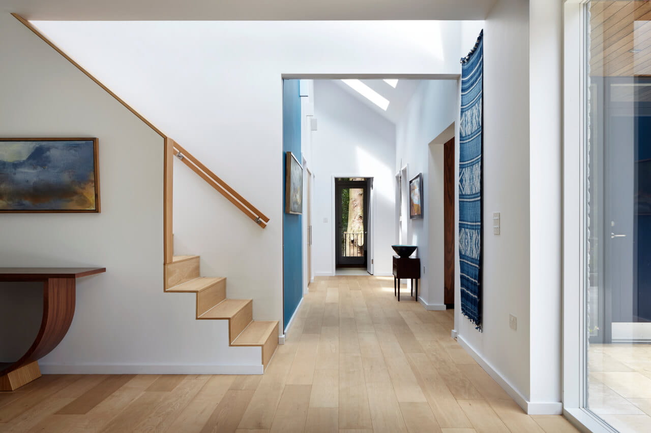 A corridor and stairs in the white painted home area