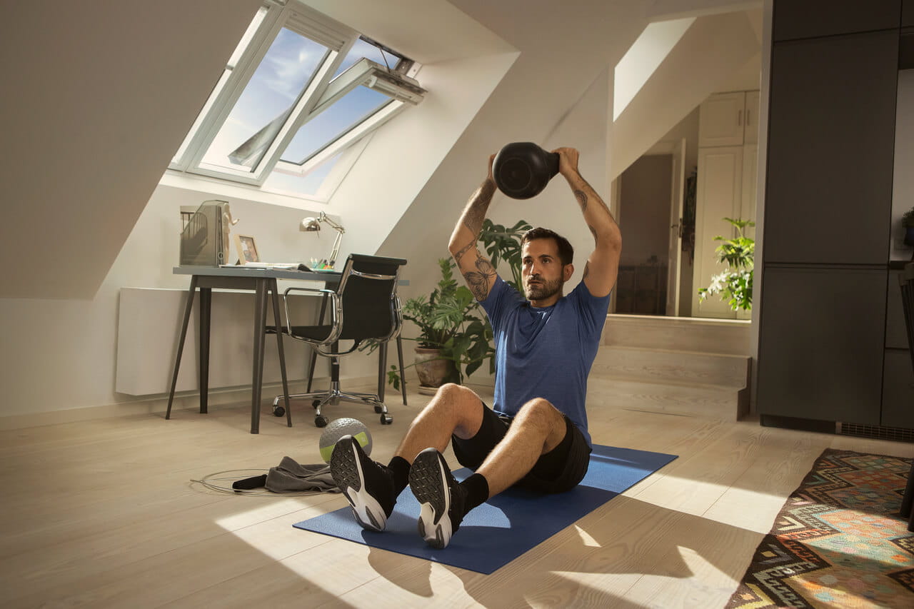 A man doing exercise on the floor in the home office