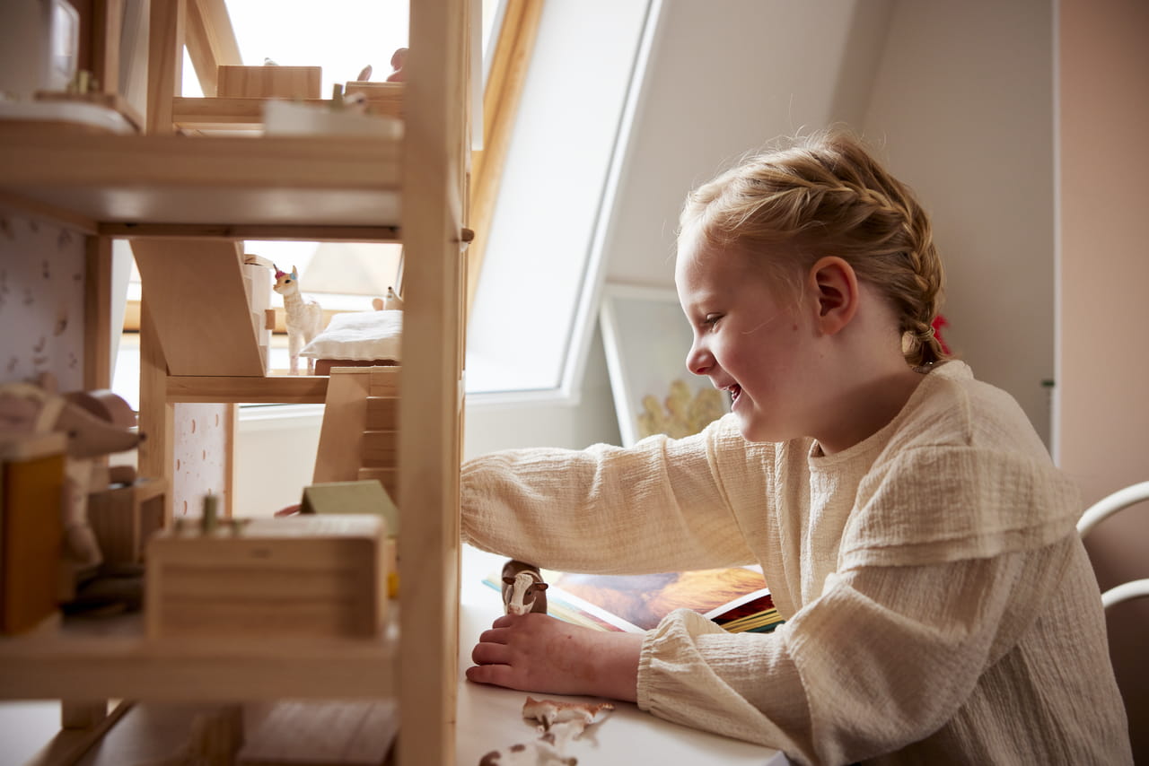 Child playing in her room with a VELUX roof window