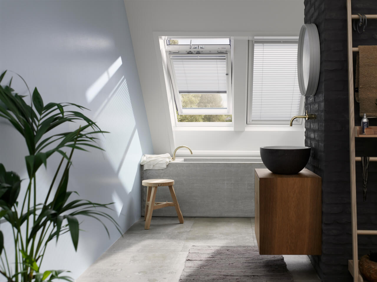 A white painted bathroom area with sink and mirror and a two roof windows with blinds