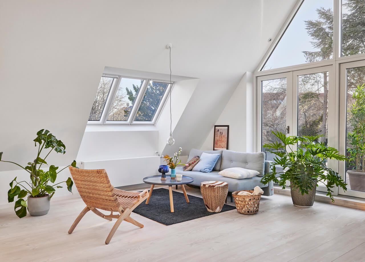 A bright living room in the attic with lots of windows