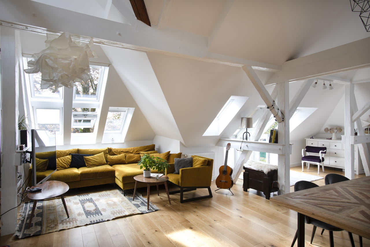 A cozy living room in the attic with 3in1 roof windows