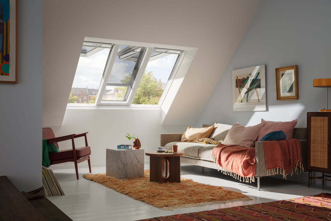 A cozy living room in the attic with 3in1 roof windows with blinds