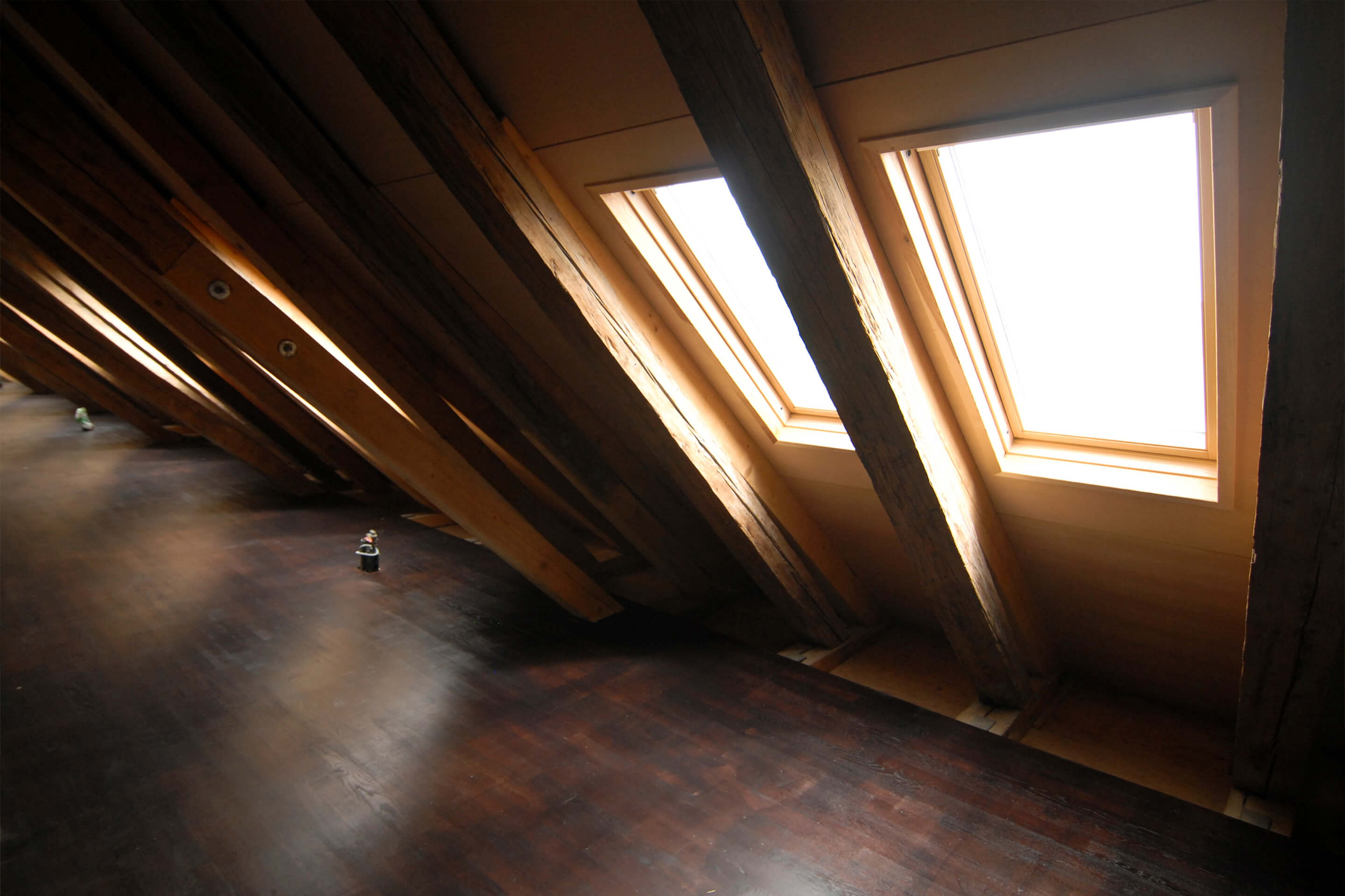 Attic space with sun light coming through roof windows