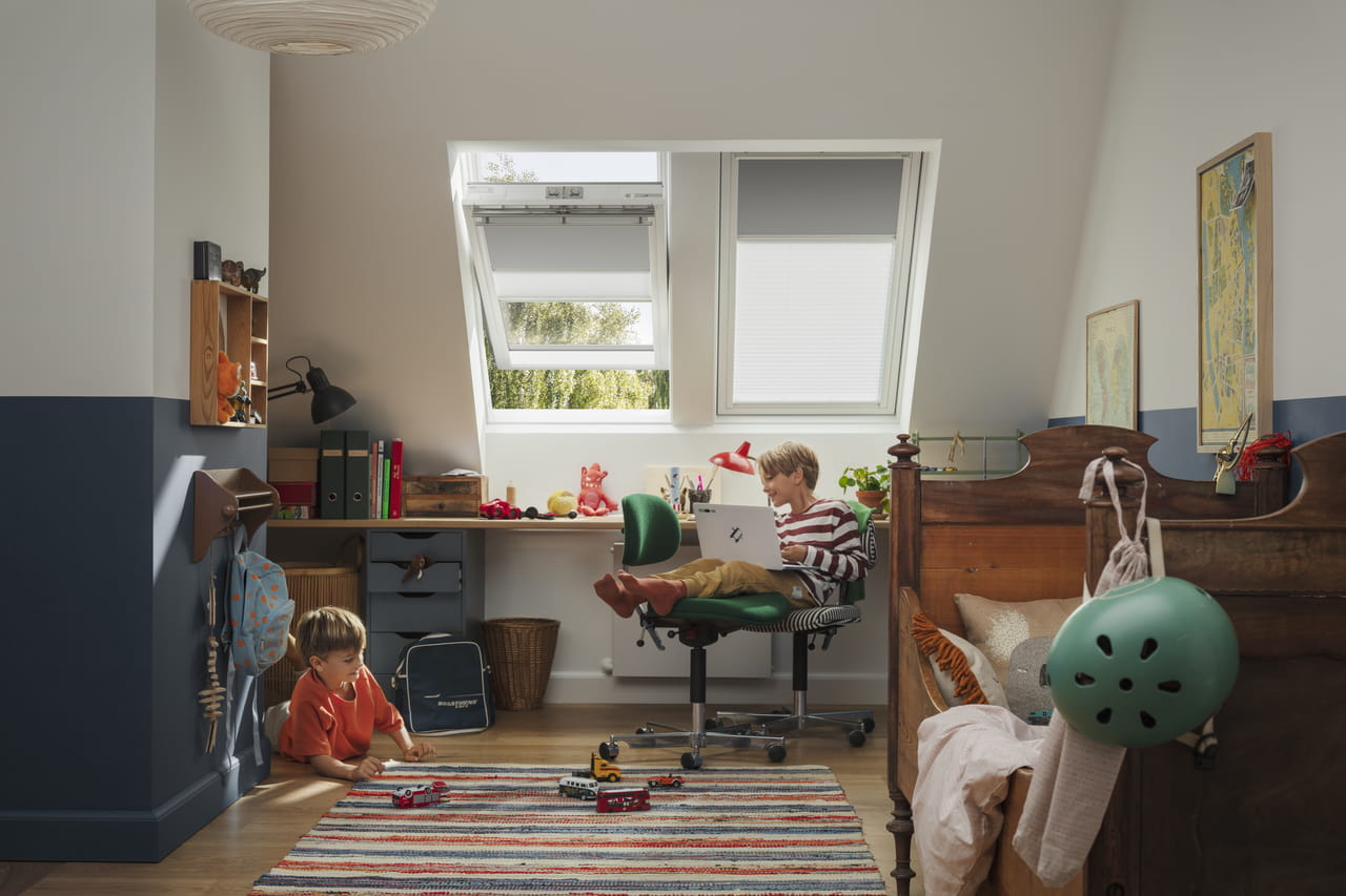 Children playing in her room with VELUX roof windows