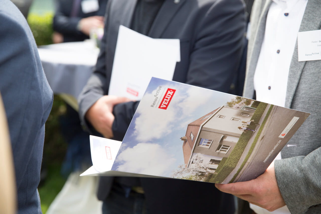 People holding VELUX brochure in their hands