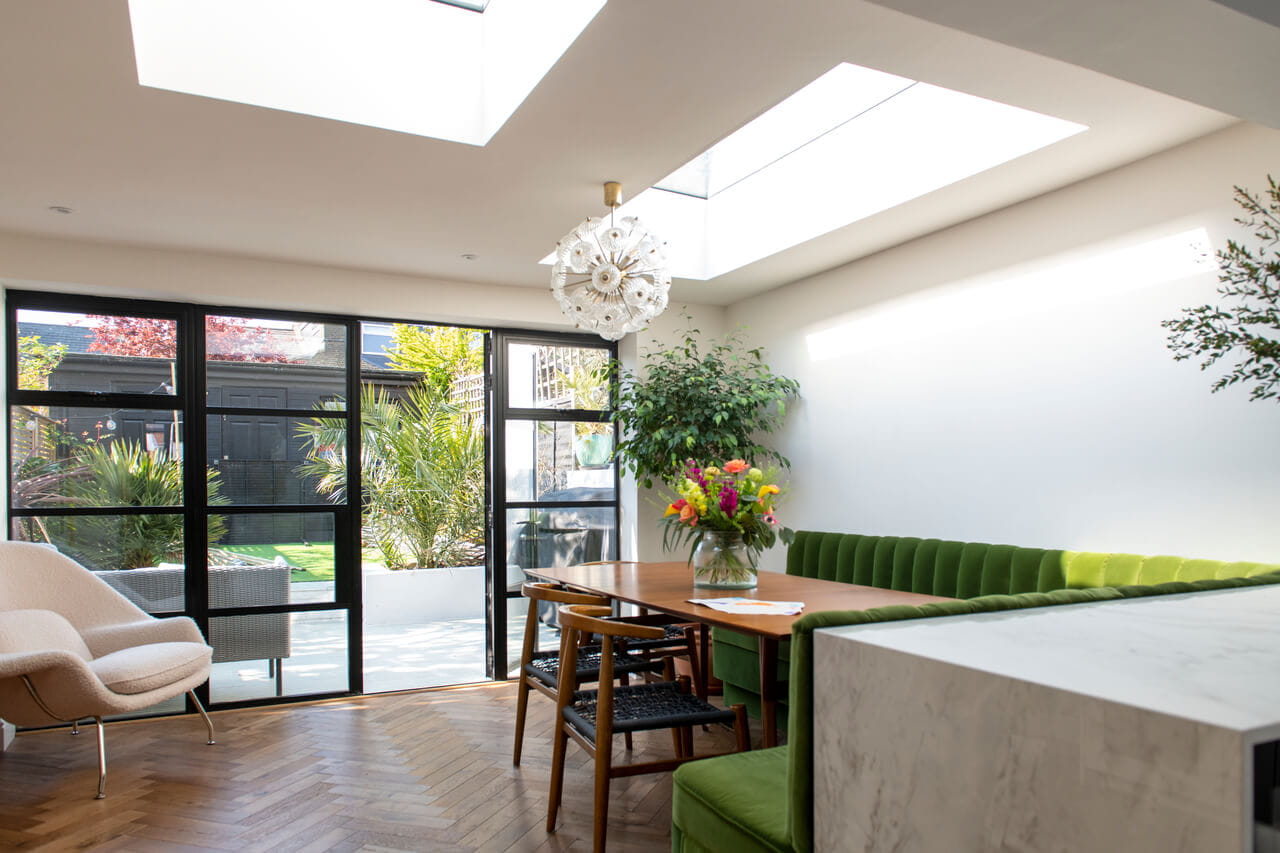 Sunny dining room area with flat roof windows