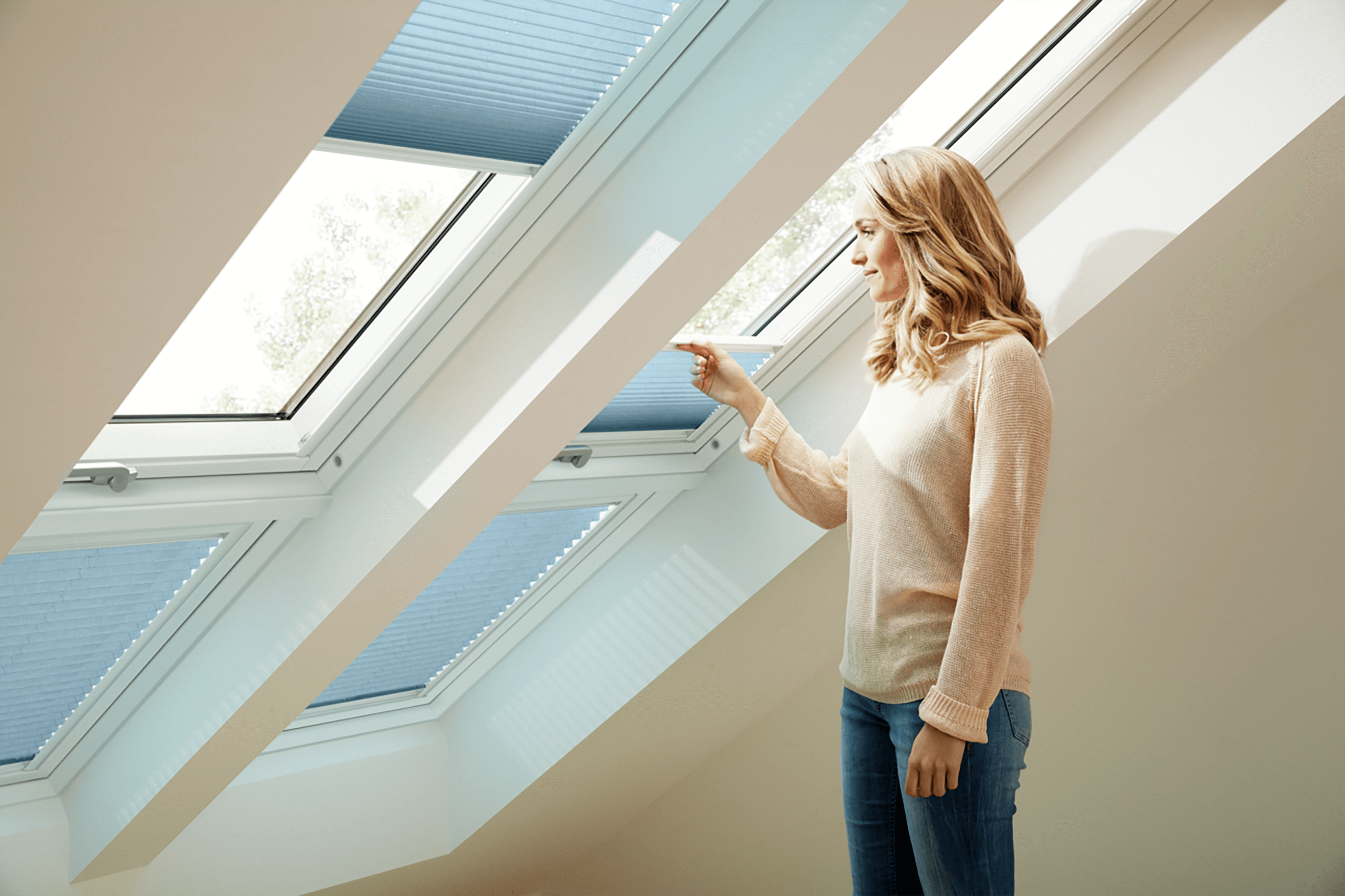 Woman opening blue blind on double roof window