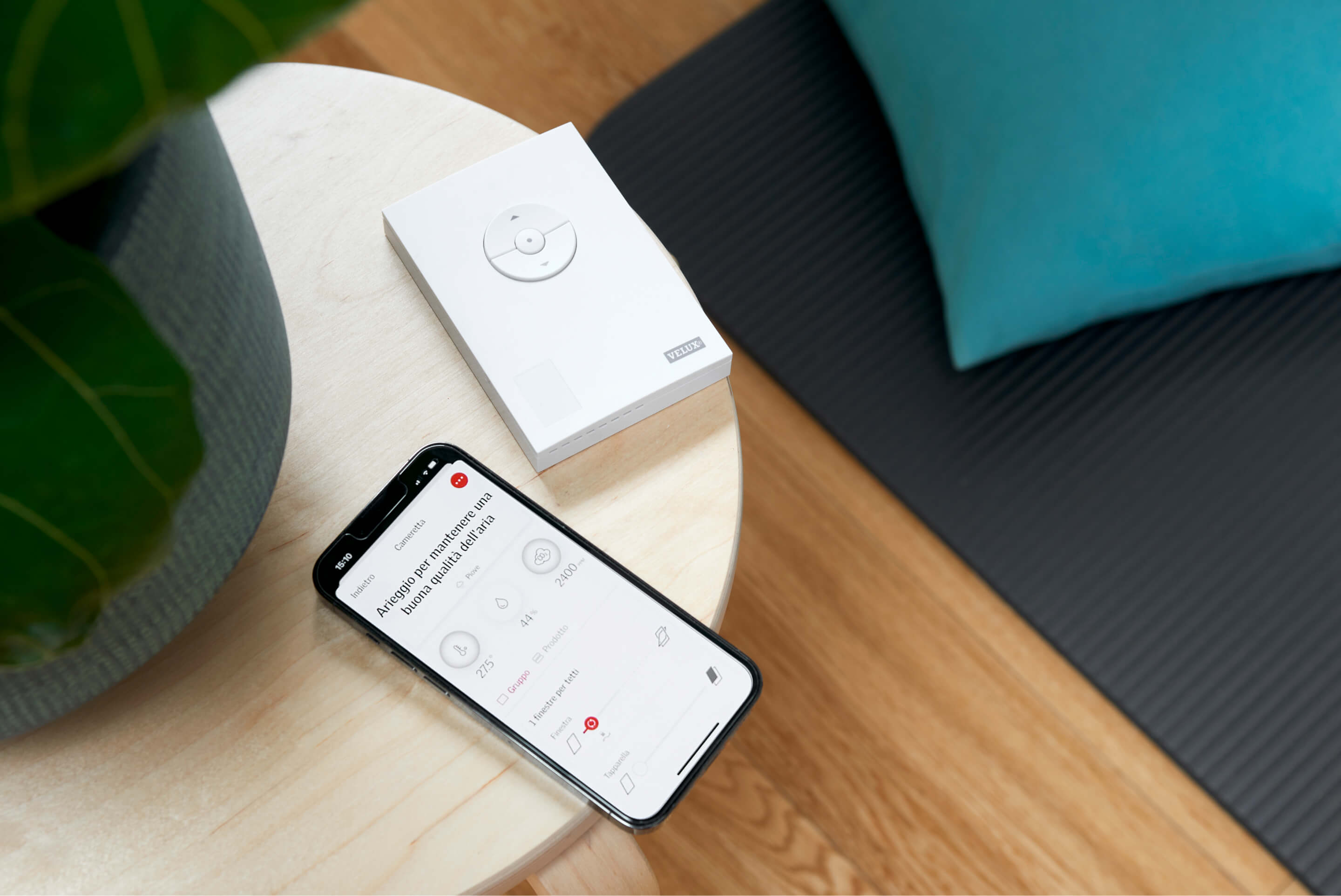 A phone with VELUX app and a remote controller for VELUX ACTIVE on the table
