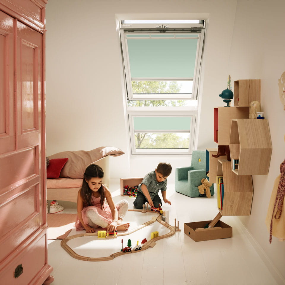 Kids room with kids playing by the window with blinds
