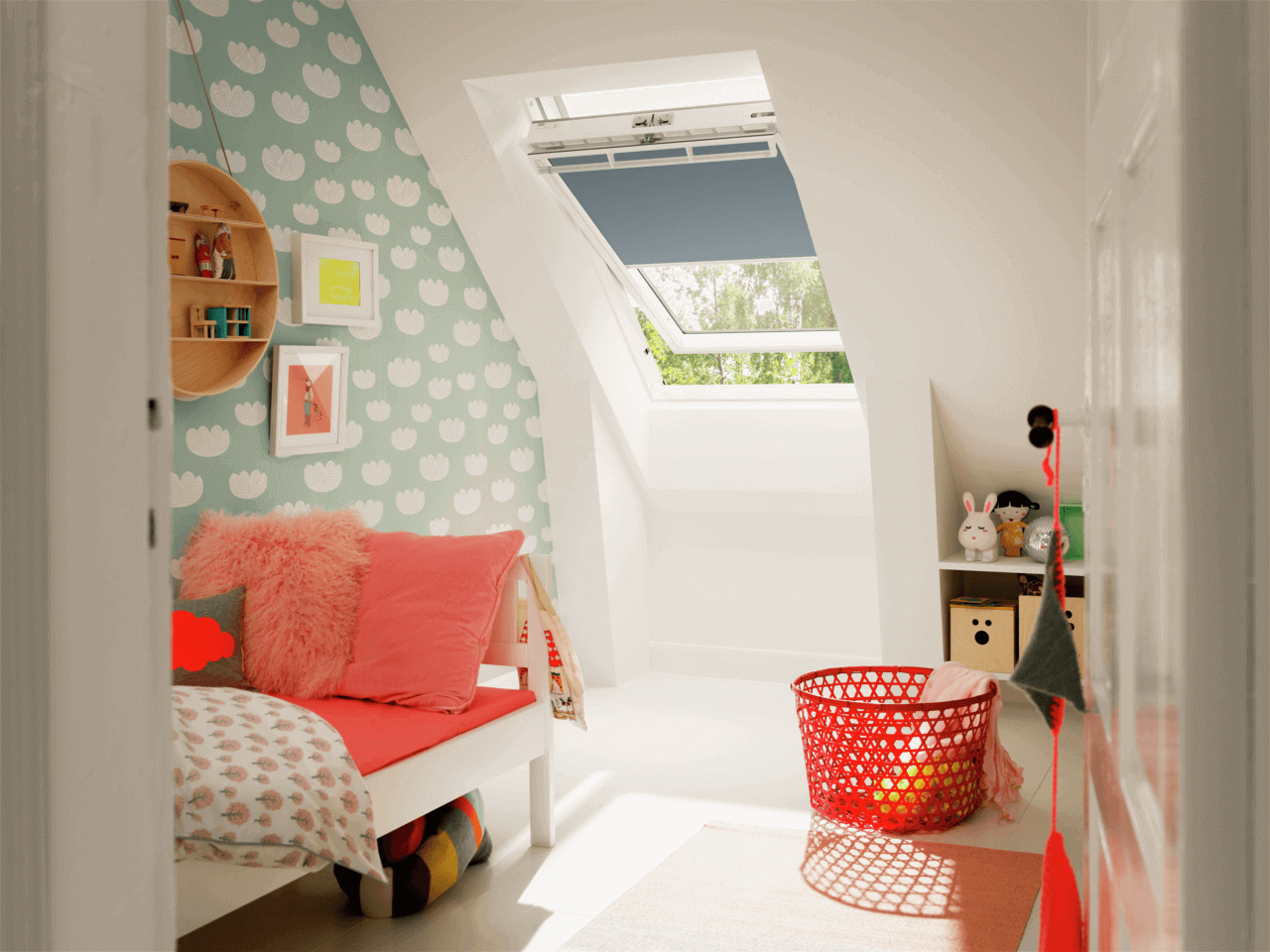 A colorful kids room with a roof window and blinds