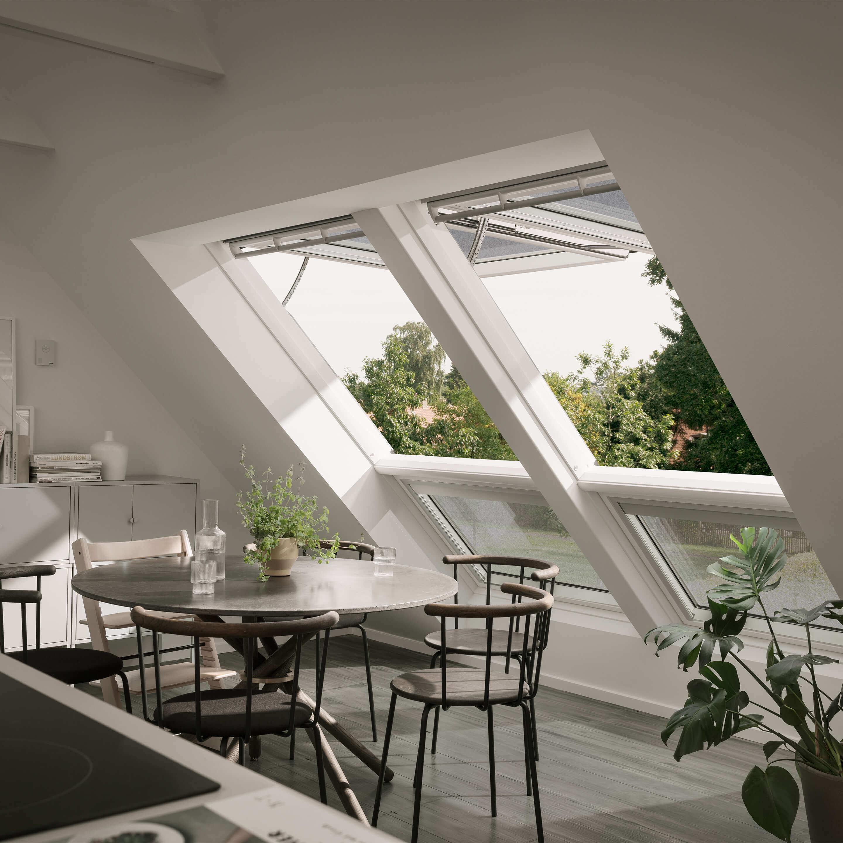 Kitchen and dining area with large double VELUX roof window solution open to let in air