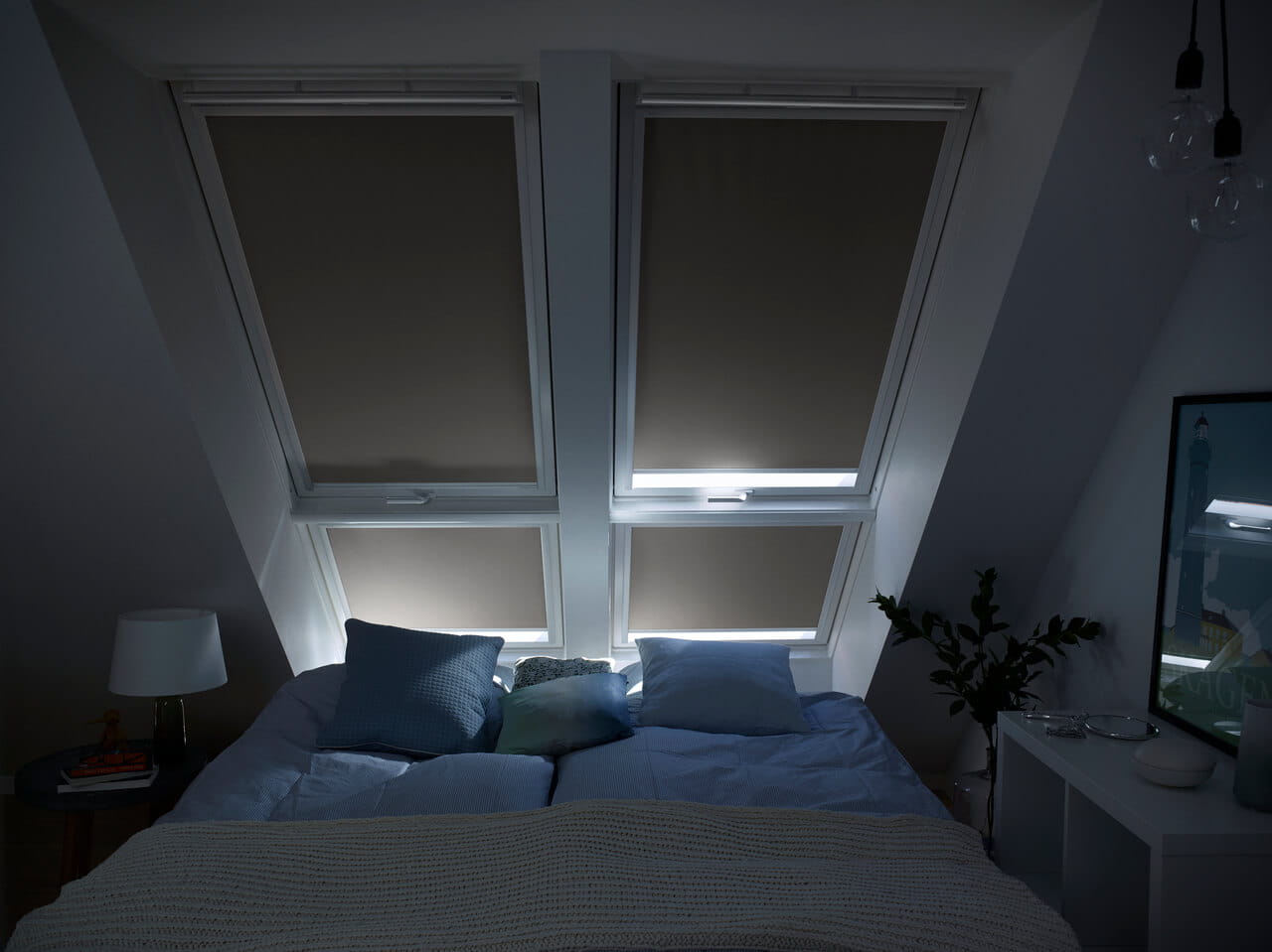 Image of almost completely drawn VELUX blackout blinds which effectively keep out the light.