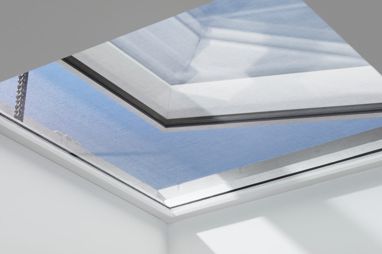 VELUX insect screen installed in an electrical flat roof windows from the inside.