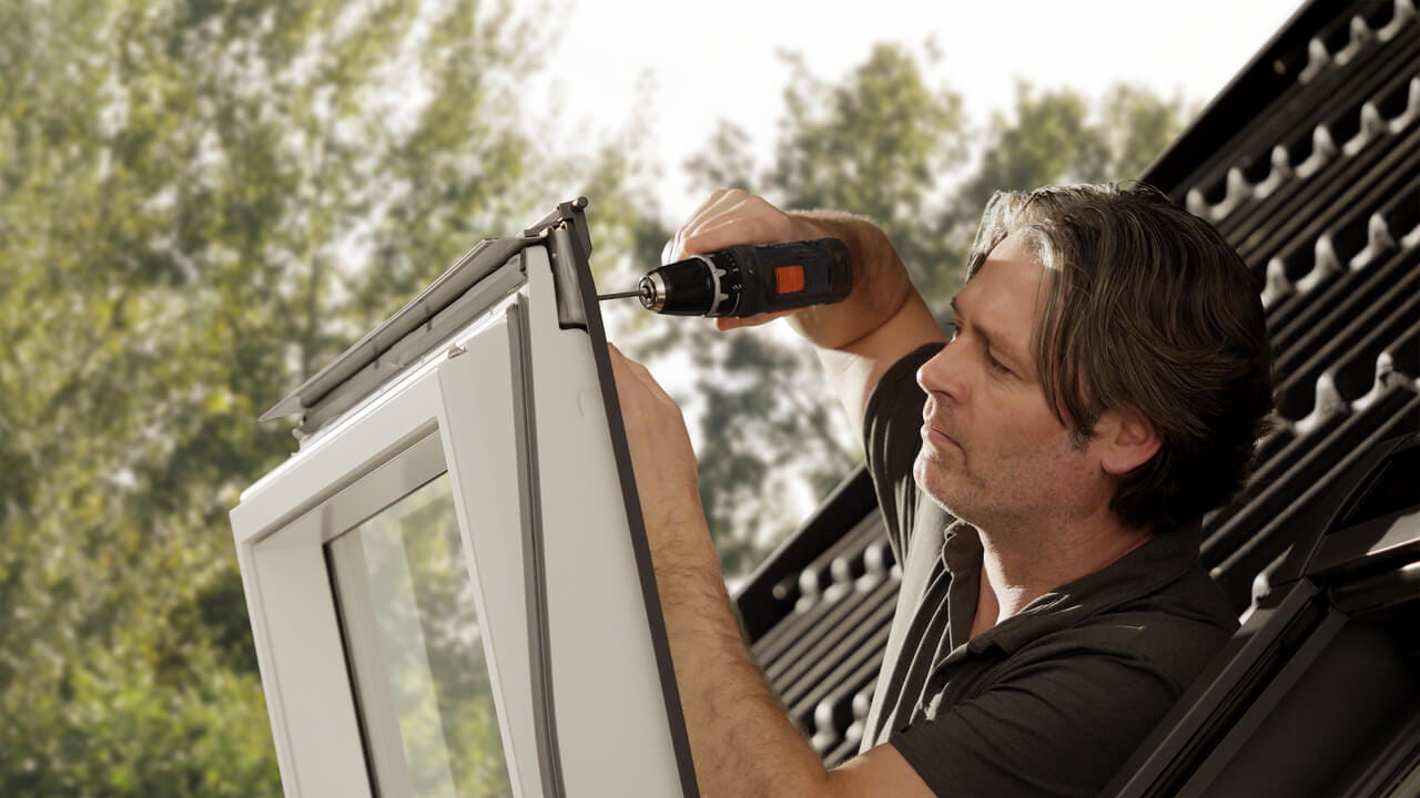 A man is installing a soft shutter