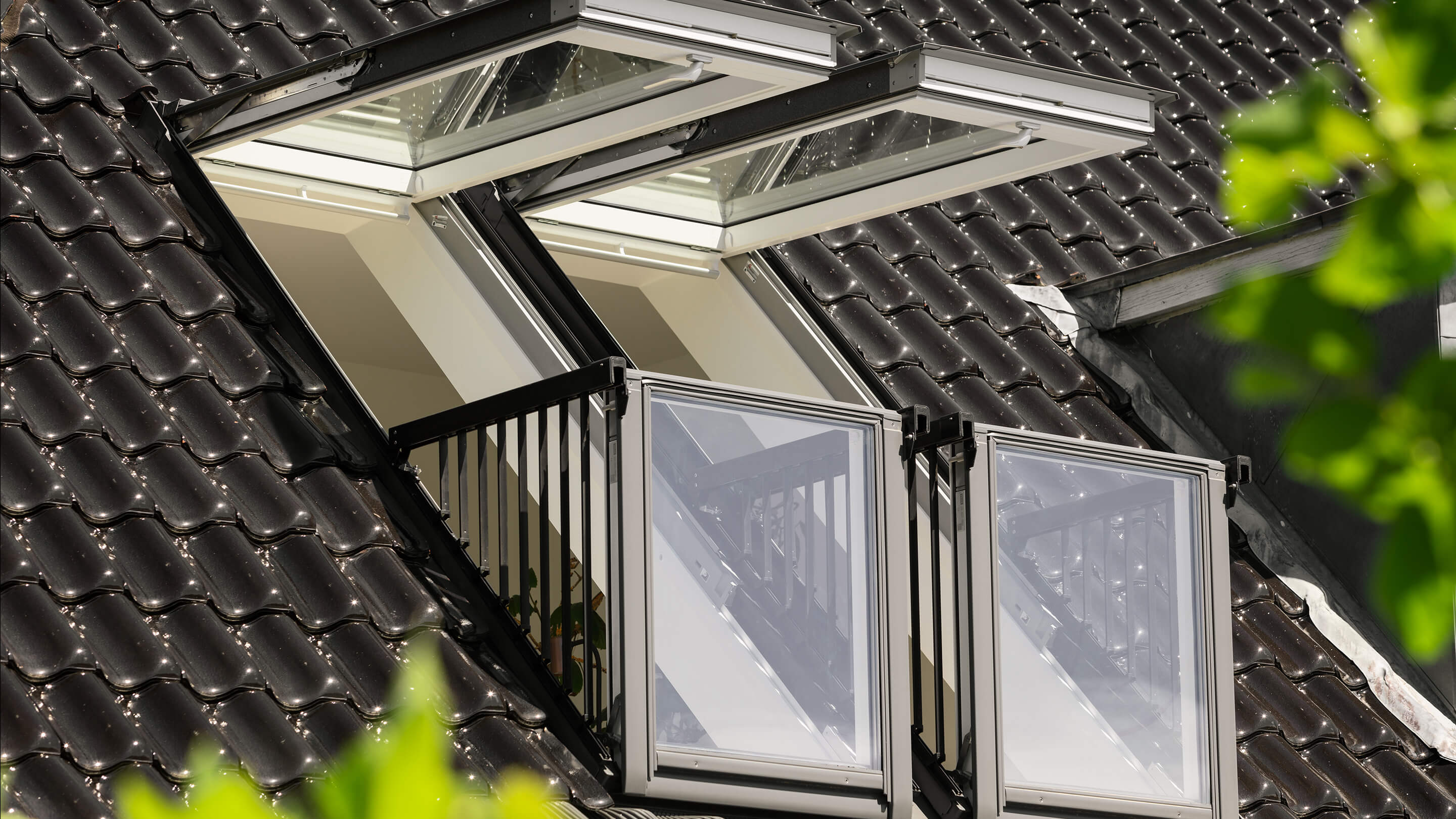 open double VELUX roof balcony in tiled roof seen from the outside