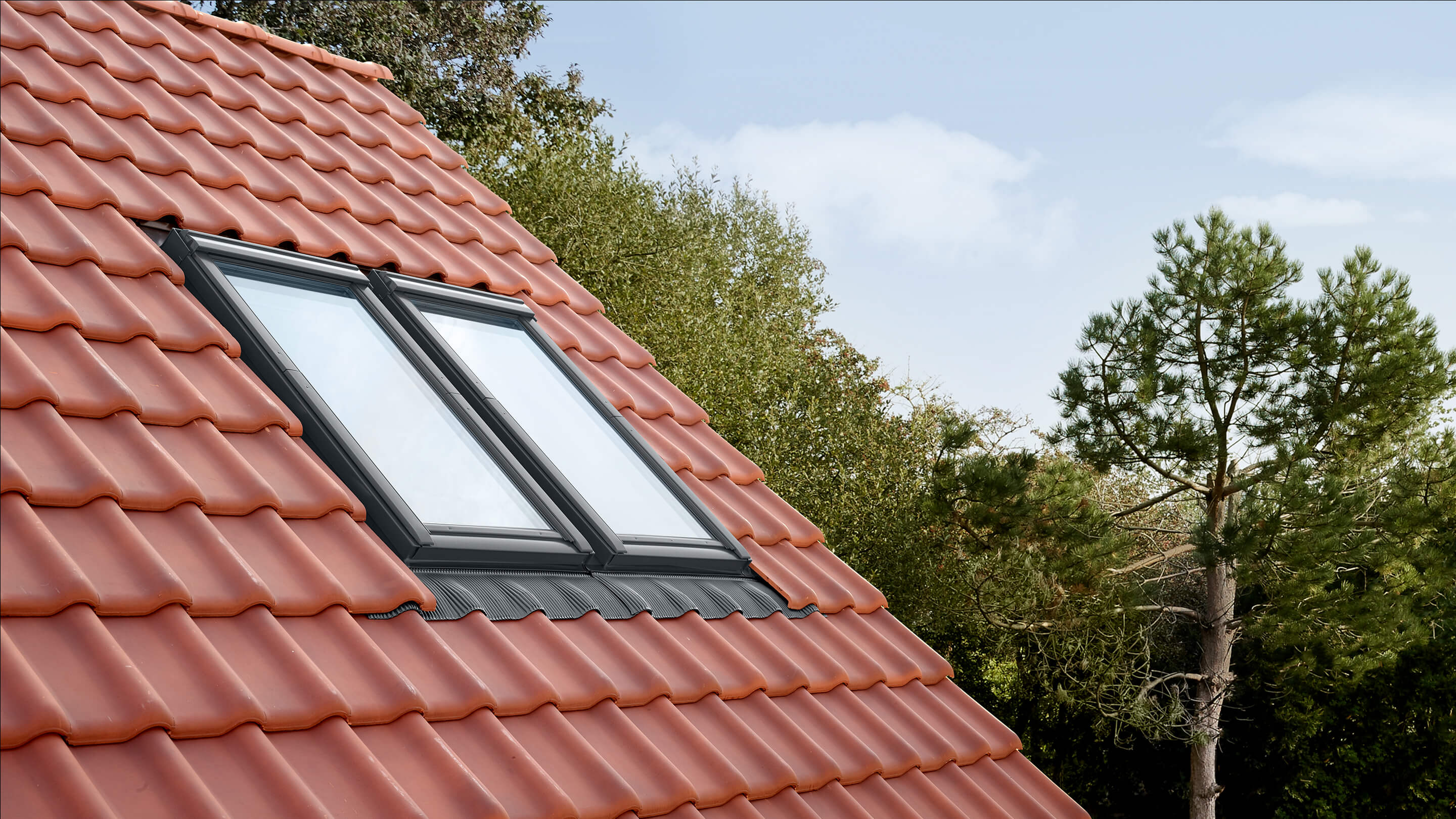 VELUX side by side roof windows in tiled roof outside view