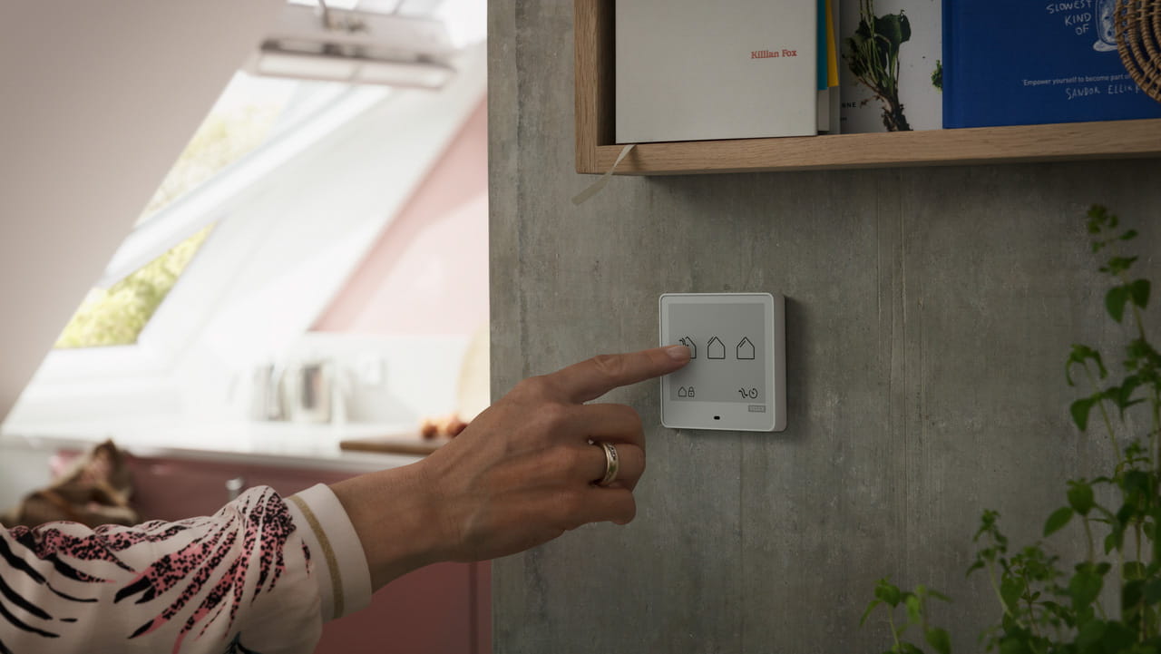 image of woman handing tapping to VELUX Touch home controller