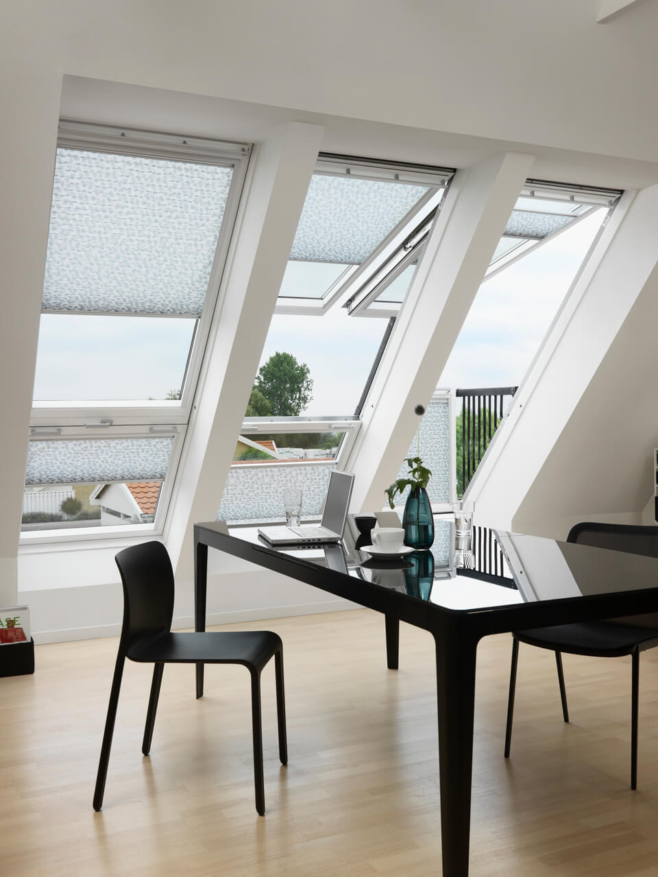 Dining room with three VELUX Cabrio balconies and translucent pleated blinds installed