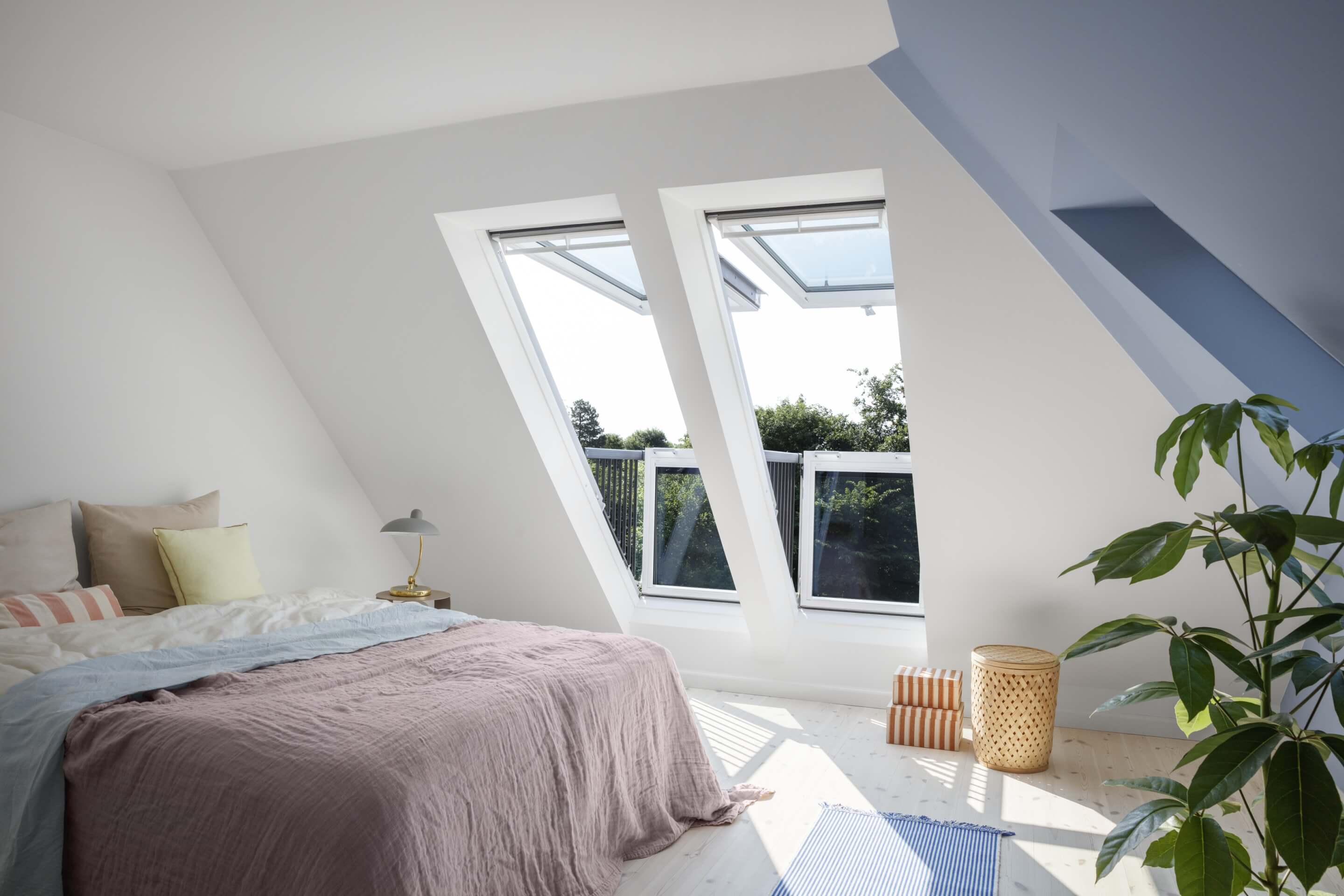 Bedroom with big bed and VELUX roof windows