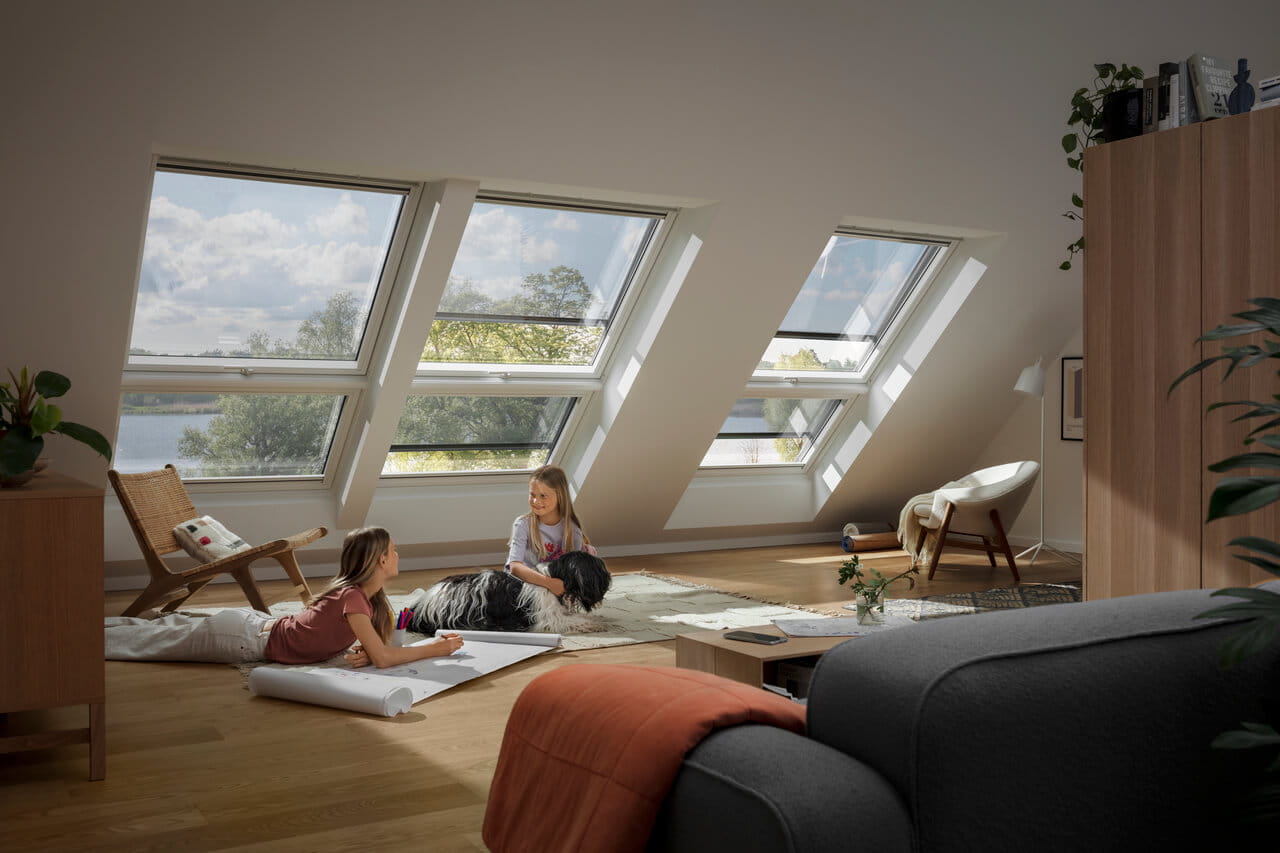 Two kids playing under VELUX roof windows