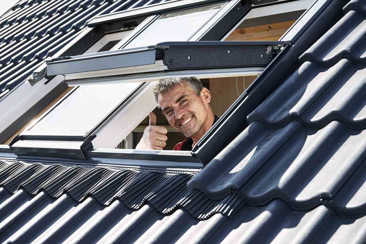 Installer looking out VELUX roof window
