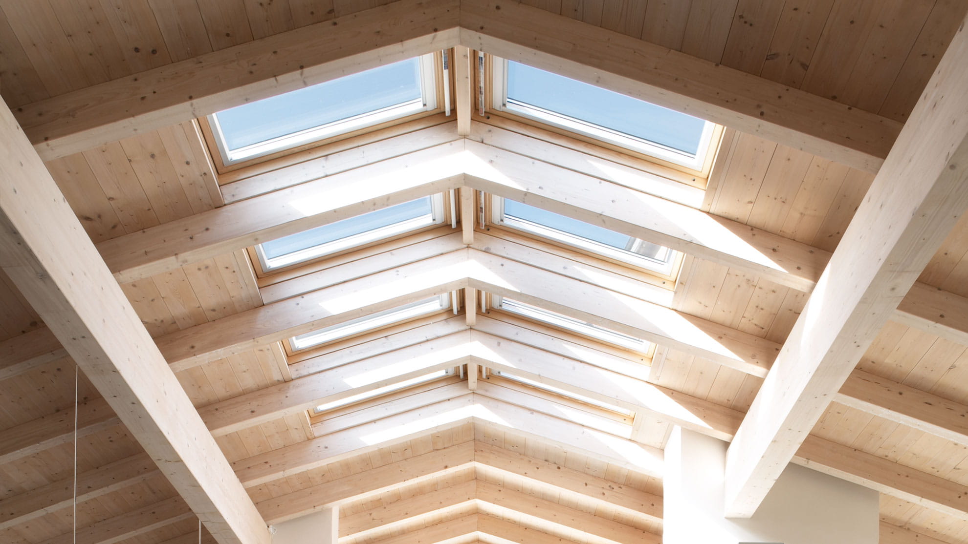 A view of a sloped roof with roof windows installed