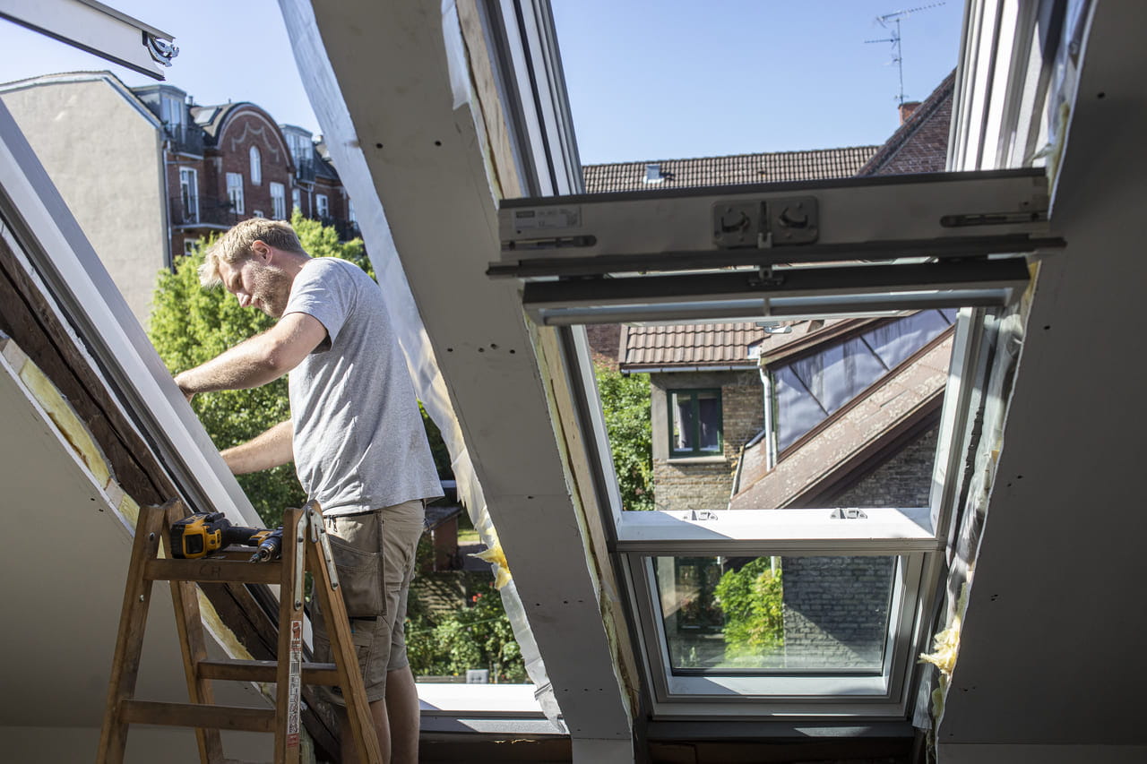 Installer working with a roof window