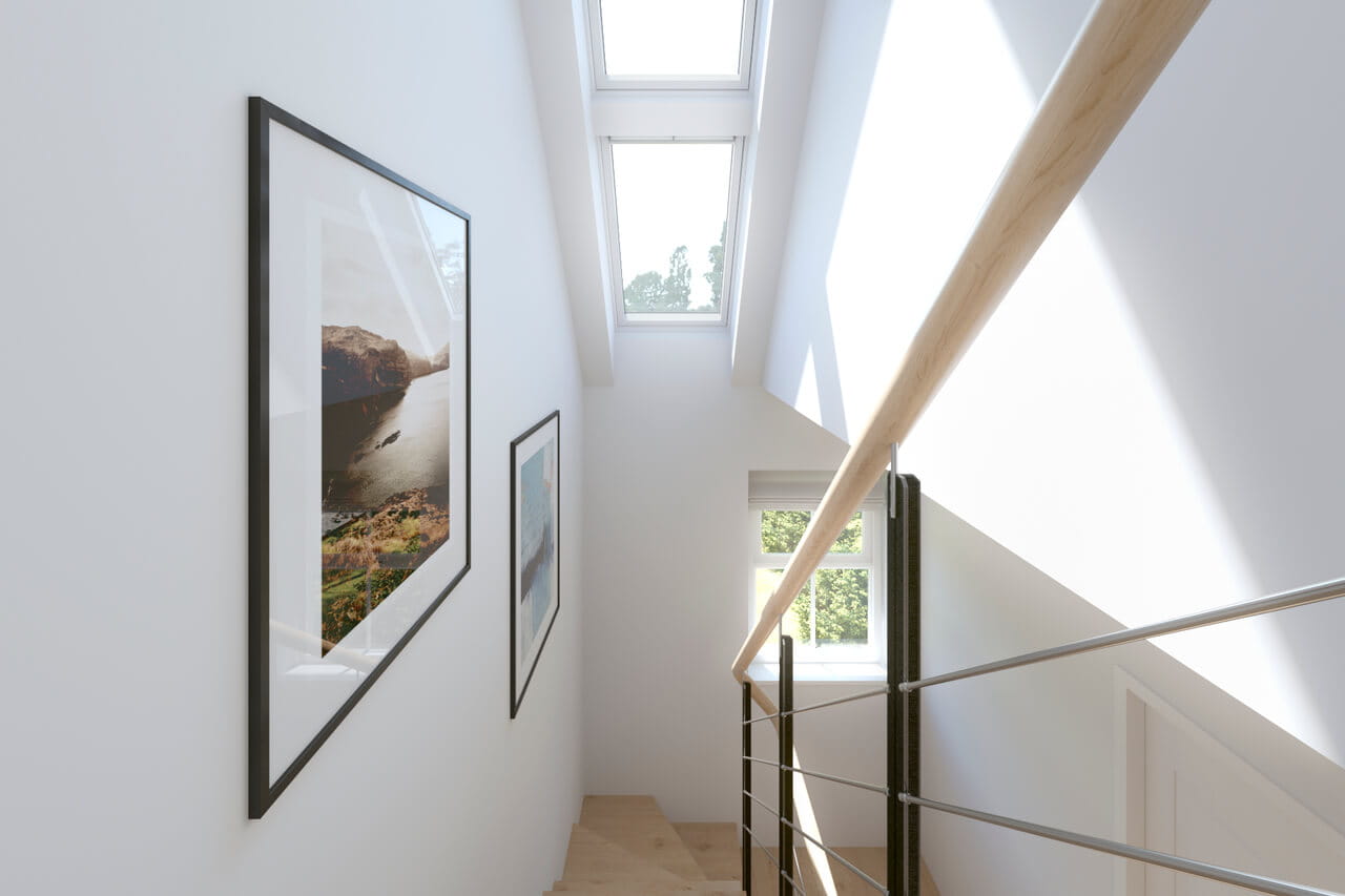Staircase with white walls and photography's and a roof window that gives a lot of sunlight
