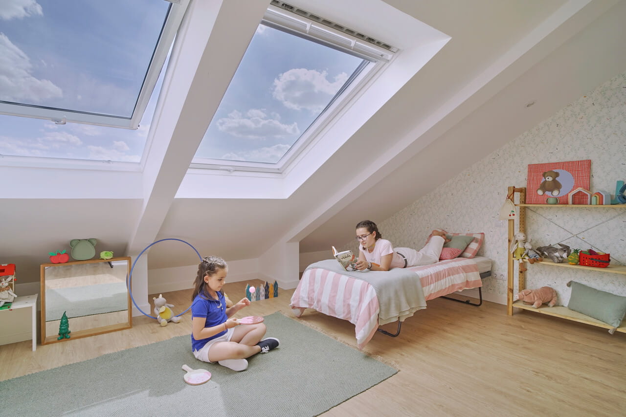 Two girls in the kids room with two roof windows