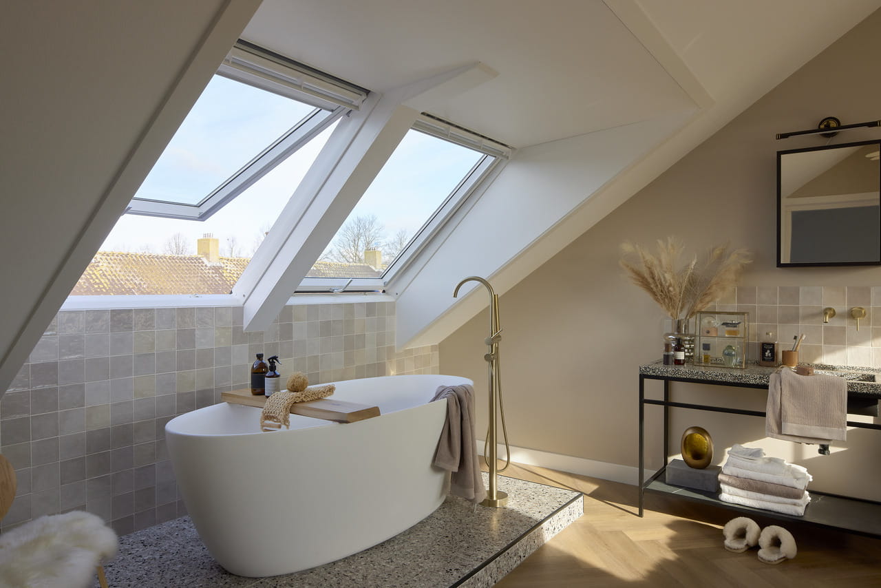 bright bathroom with two sloped roof windows.