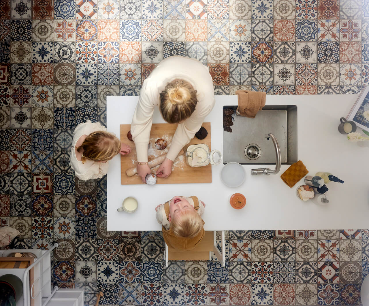 A view from above to the woman and two kids in the kitchen.