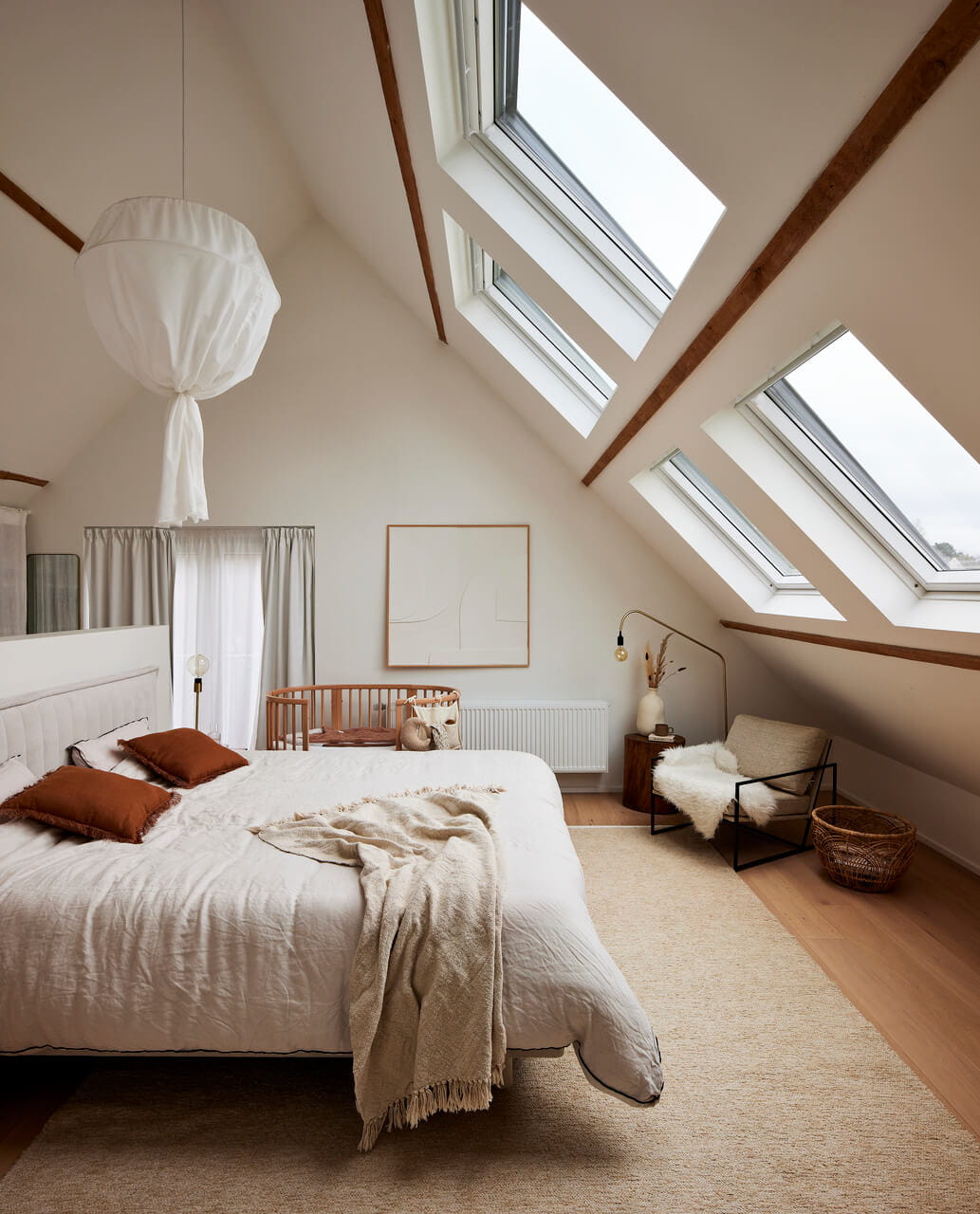 Very bright and sunny bedroom in the attic with roof windows.