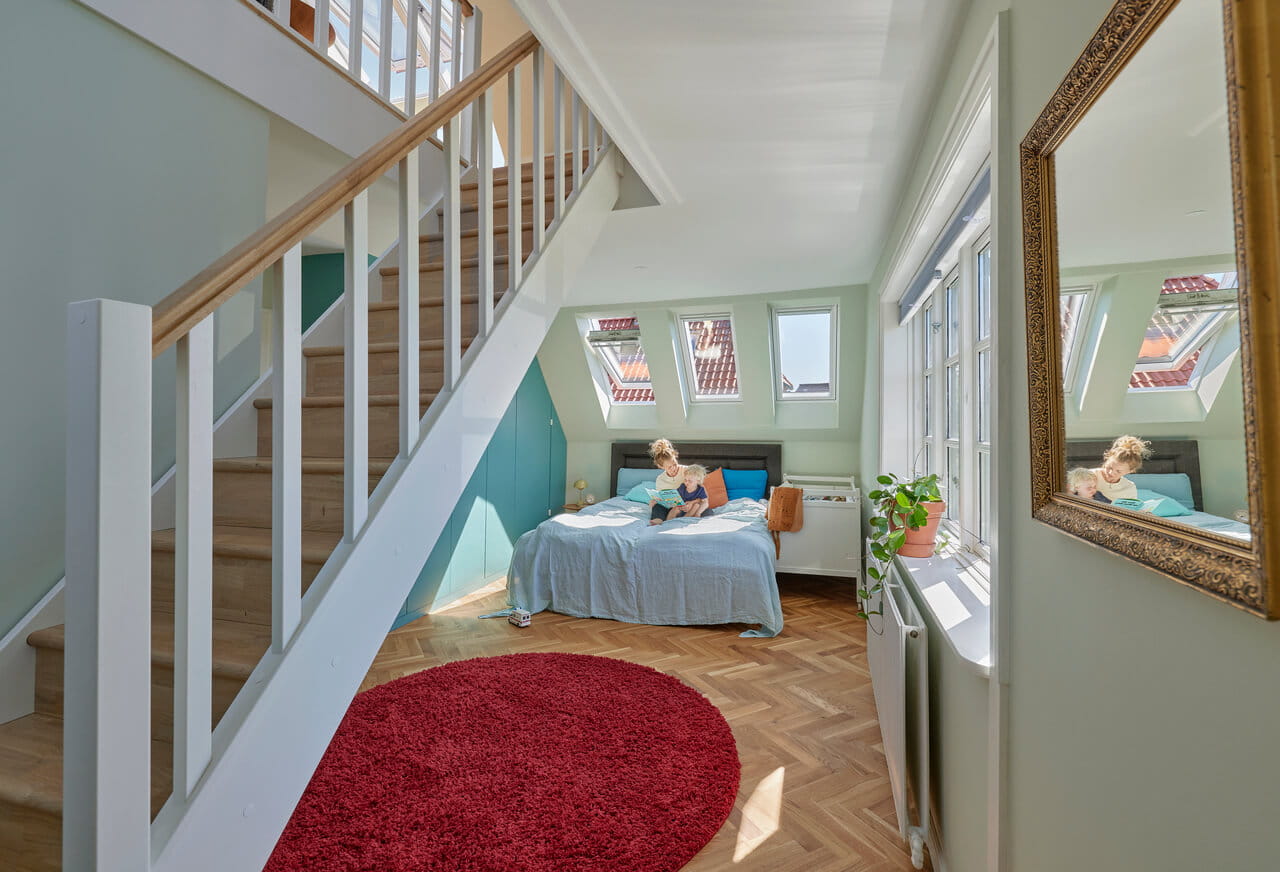 Bright bedroom space under staircase.
