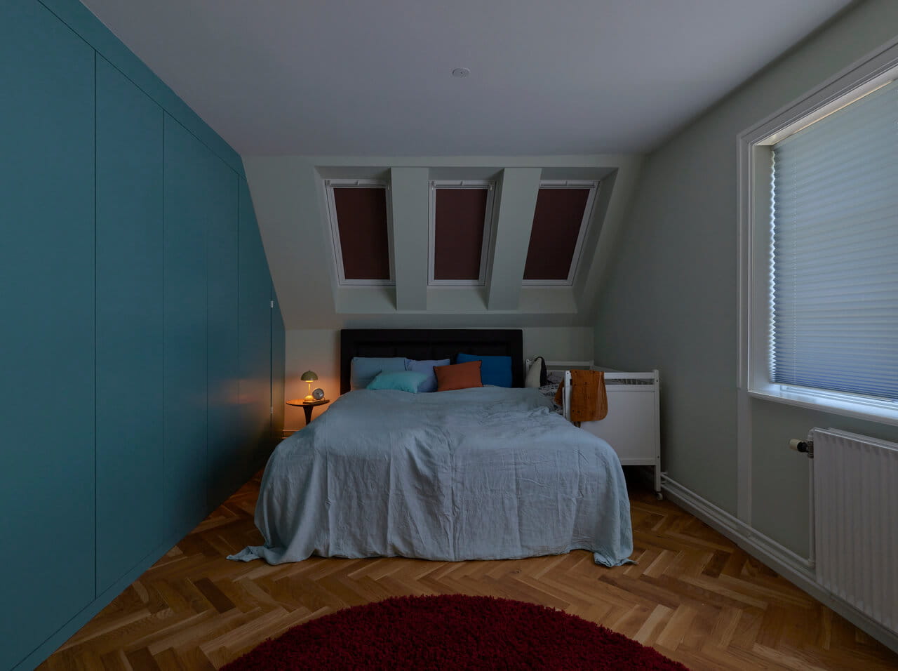 Bedroom with roof windows covered with blinds.