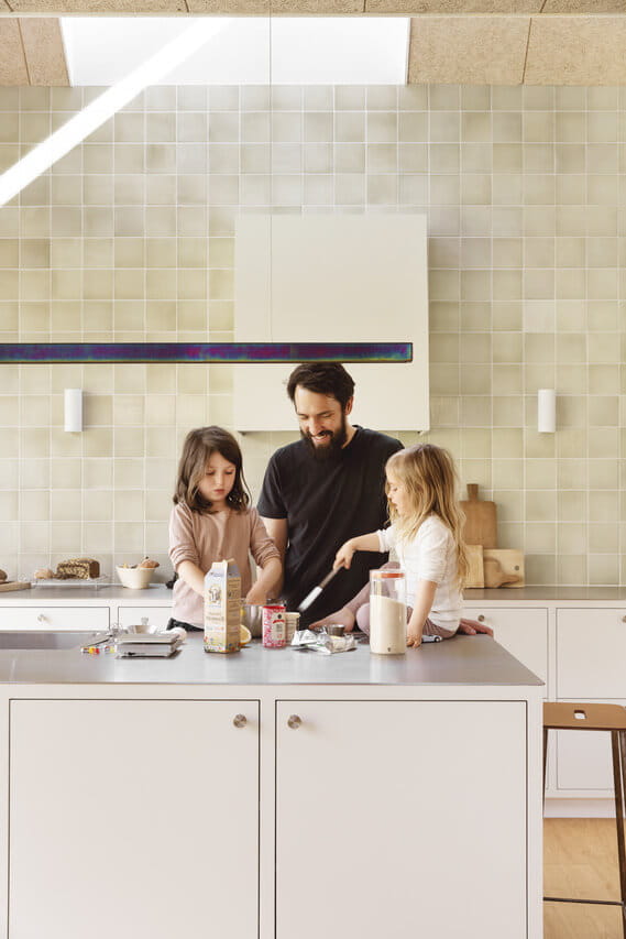 Man and two girls in the kitchen.