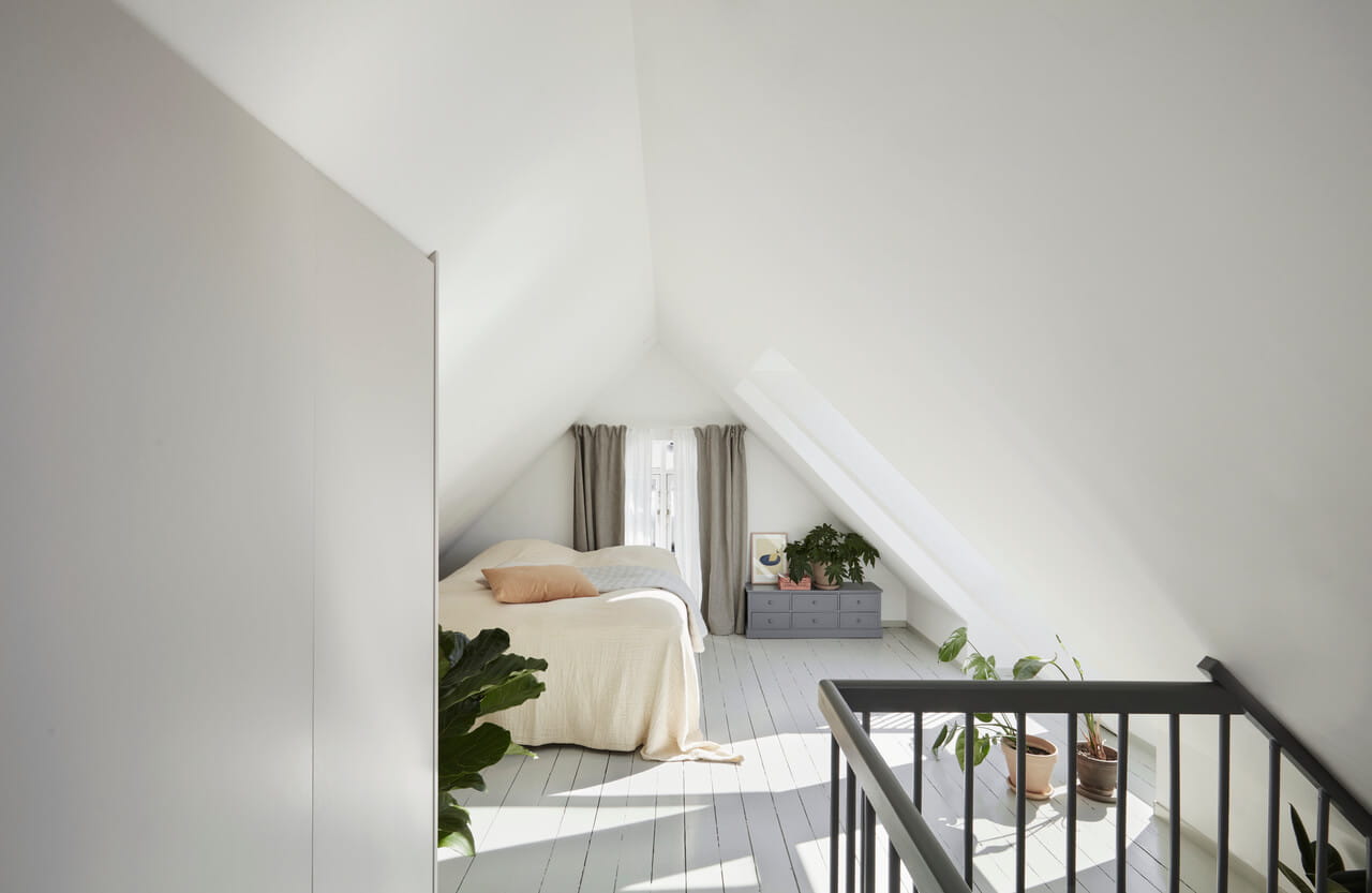 Bedroom space in the white painted attic.
