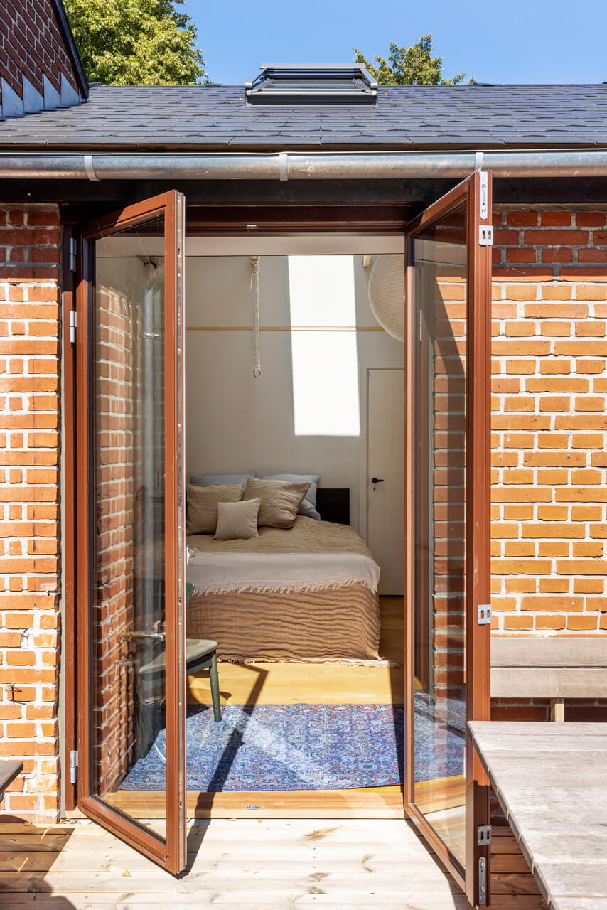 Outside view to a bedroom through the open terrace door.