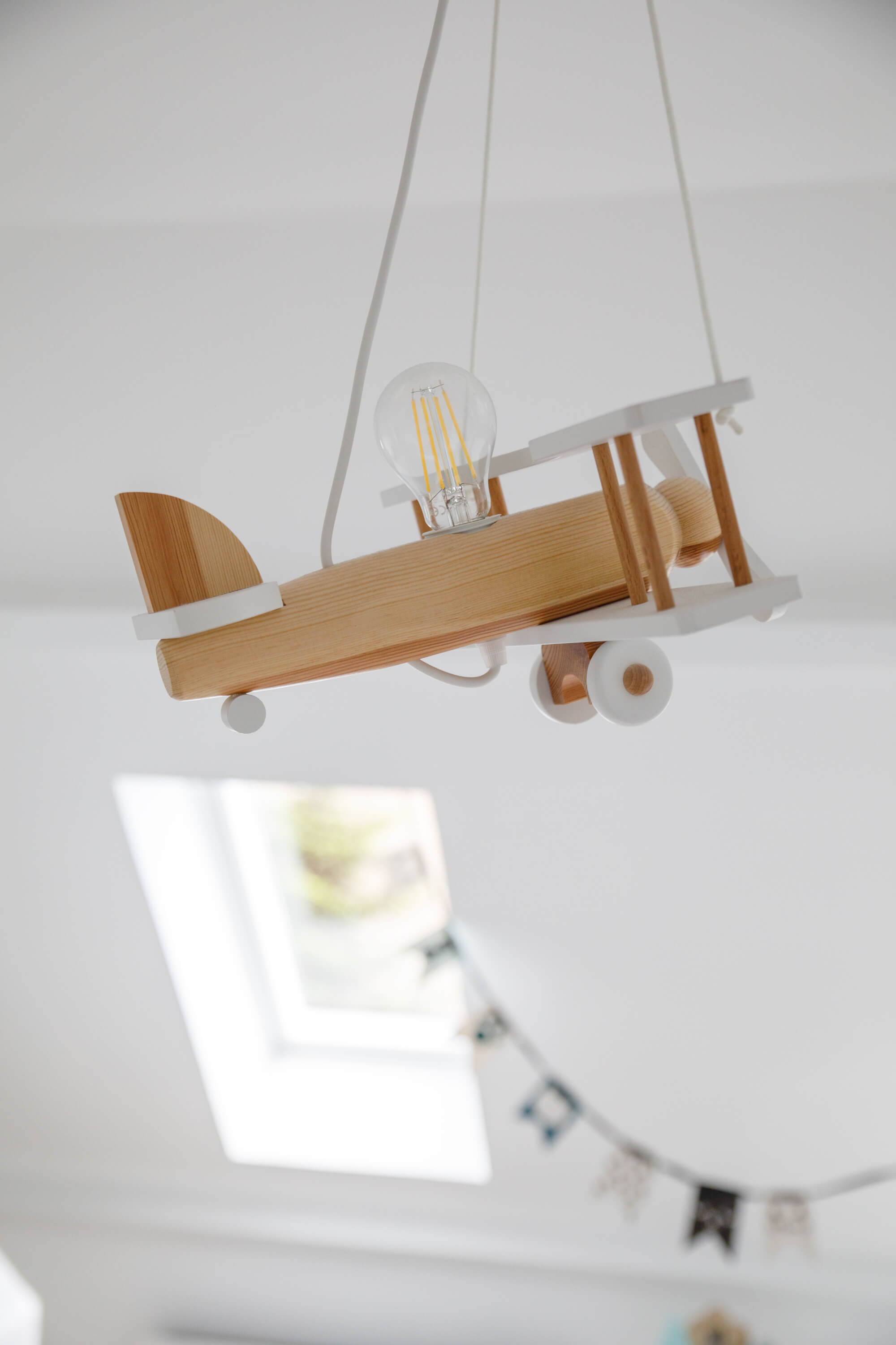 A wooden ceiling decoration in the shape of a plane