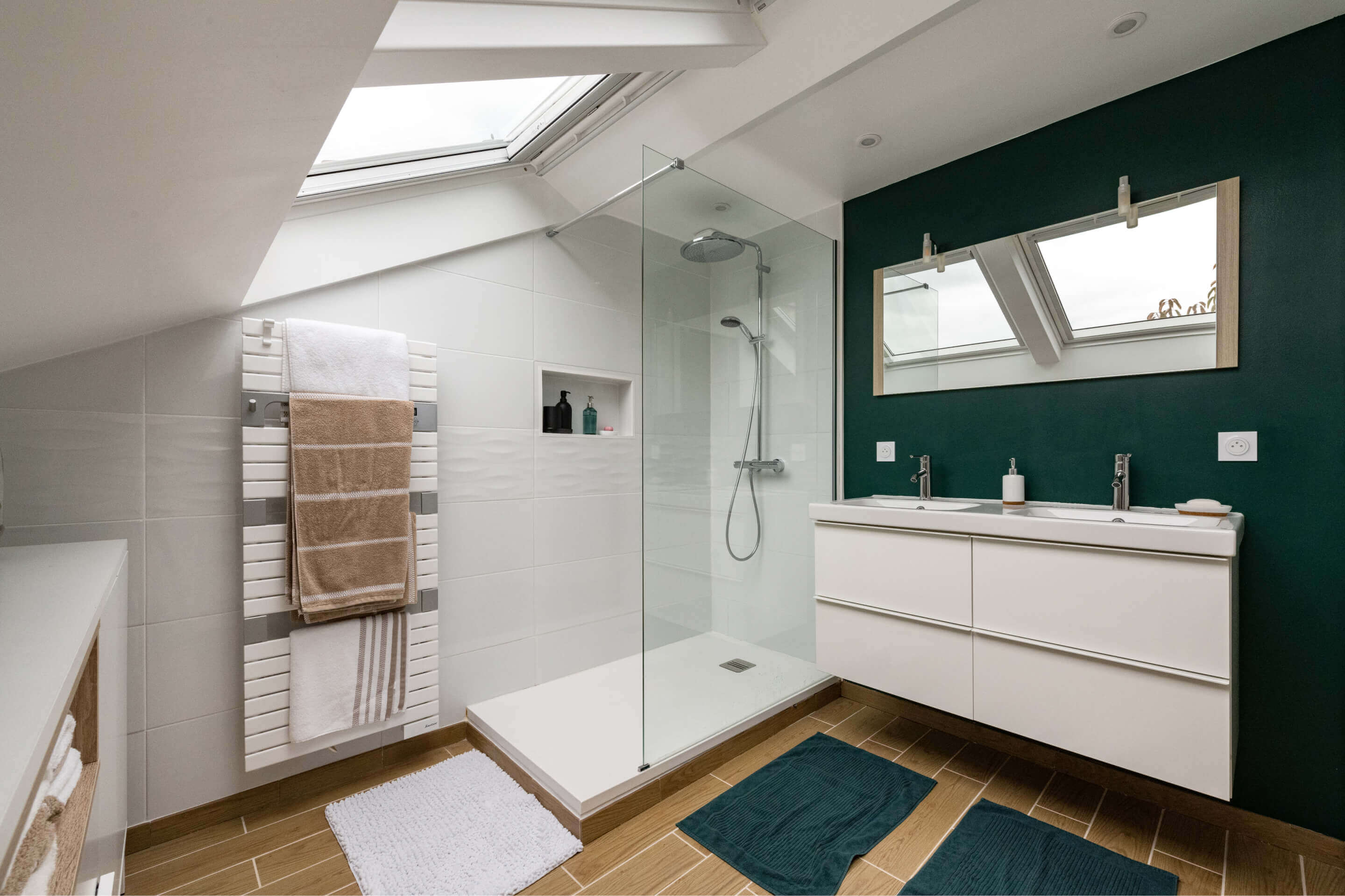 Bathroom area with sink and shower and also roof windows