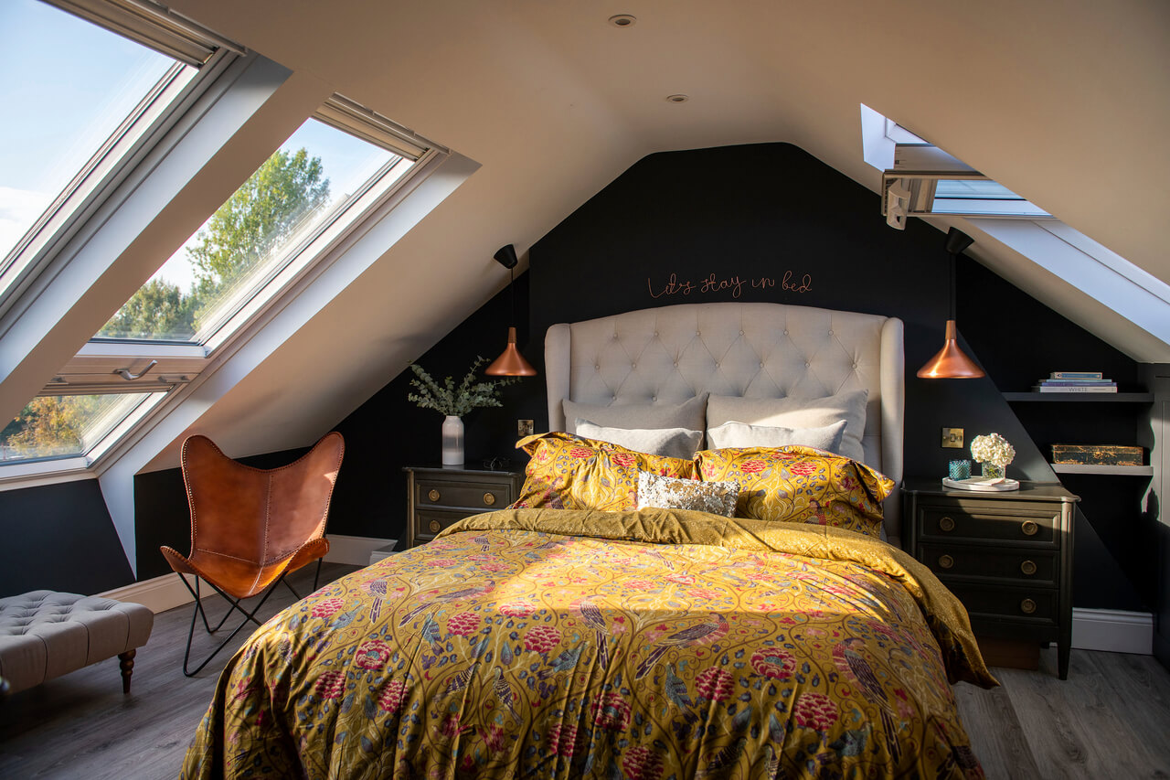Bedroom in the attic with roof windows from both sides of the roof.
