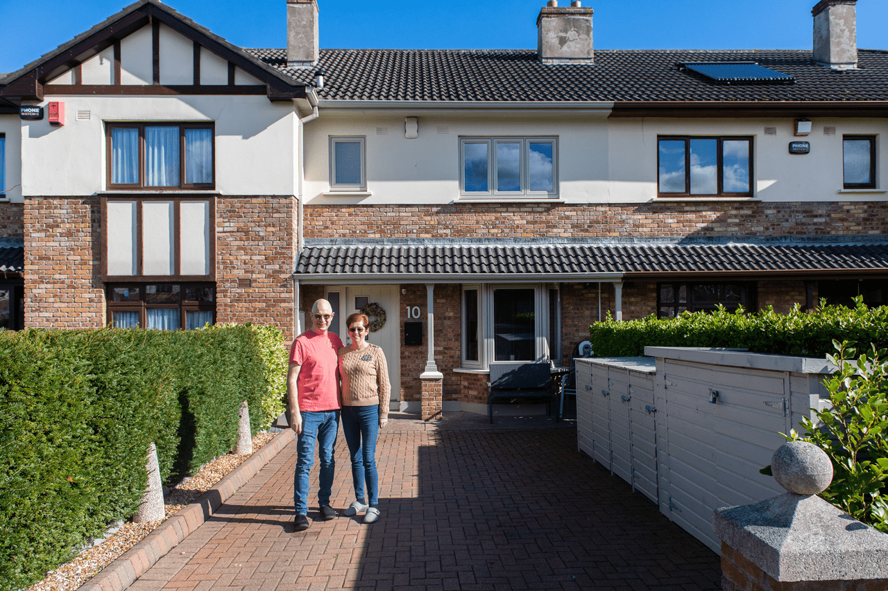 How to realise the potential of your attic space with roof windows - couple outside home