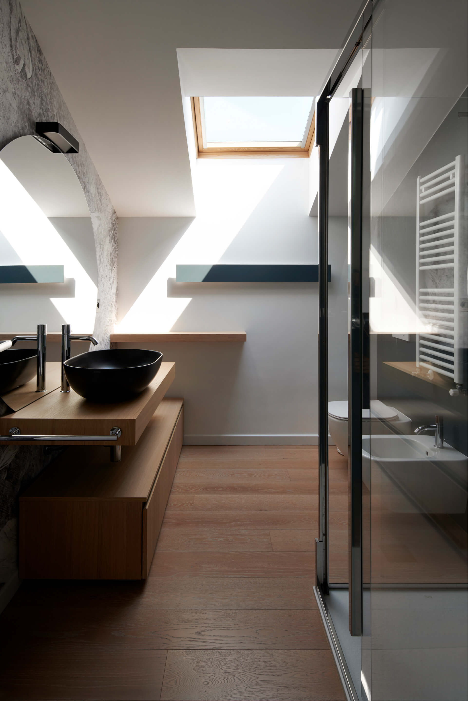 A modern bathroom area with sink and shower