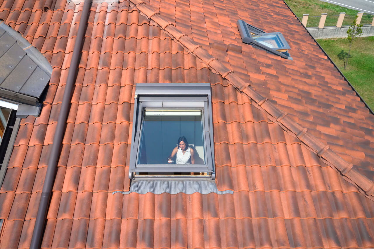 A brown tiles roof with roof winodws