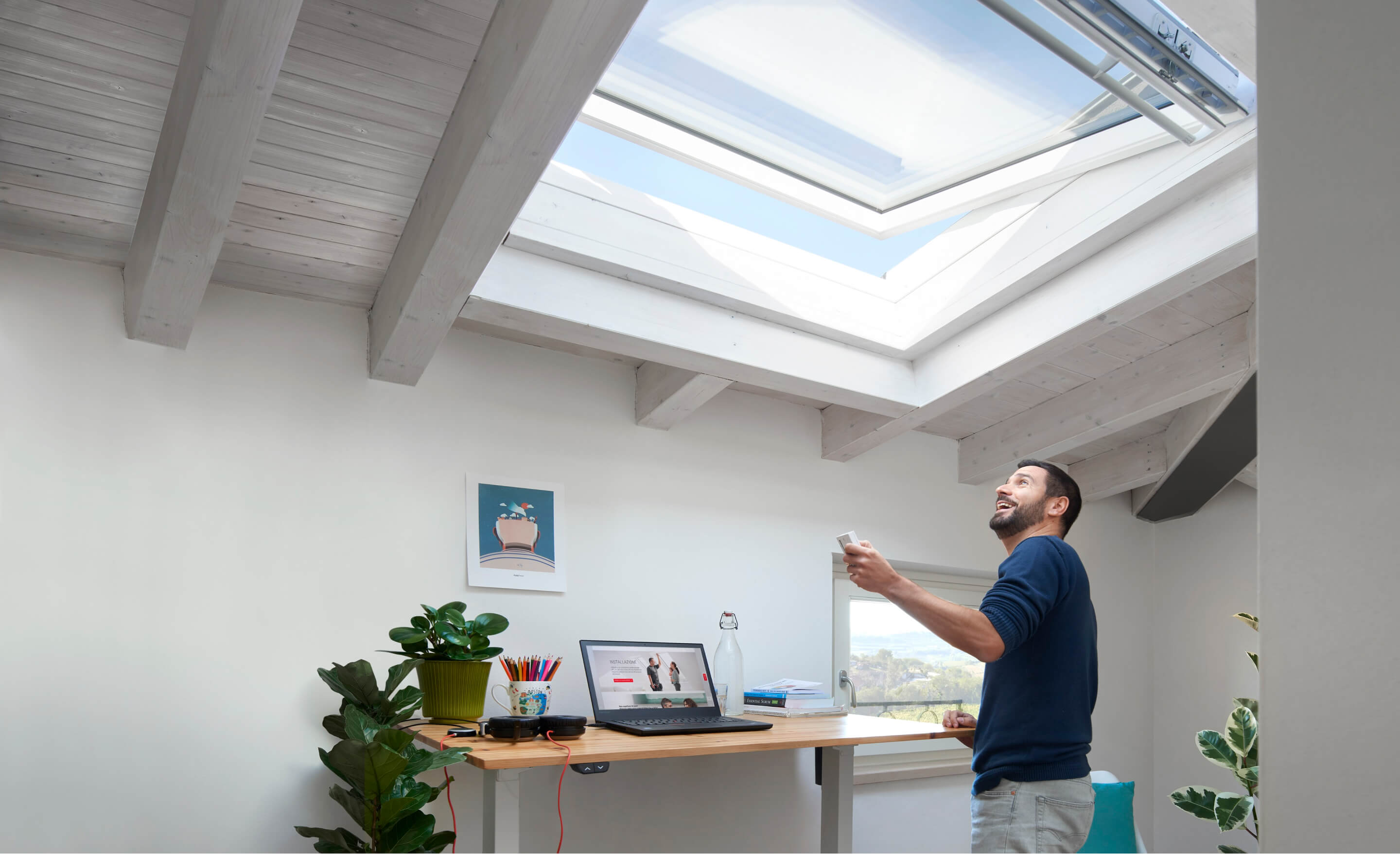 Man in a home office with roof window