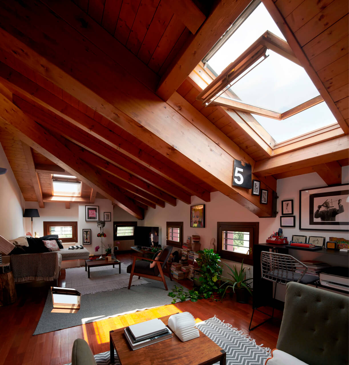 An open roof window in the living room area in the attic