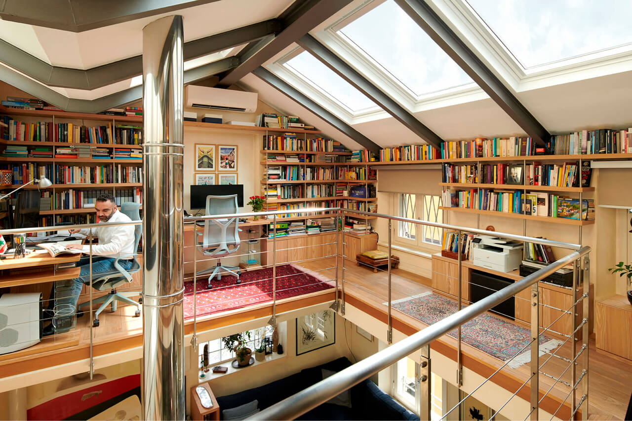 A big home library area in the bright attic with roof windows