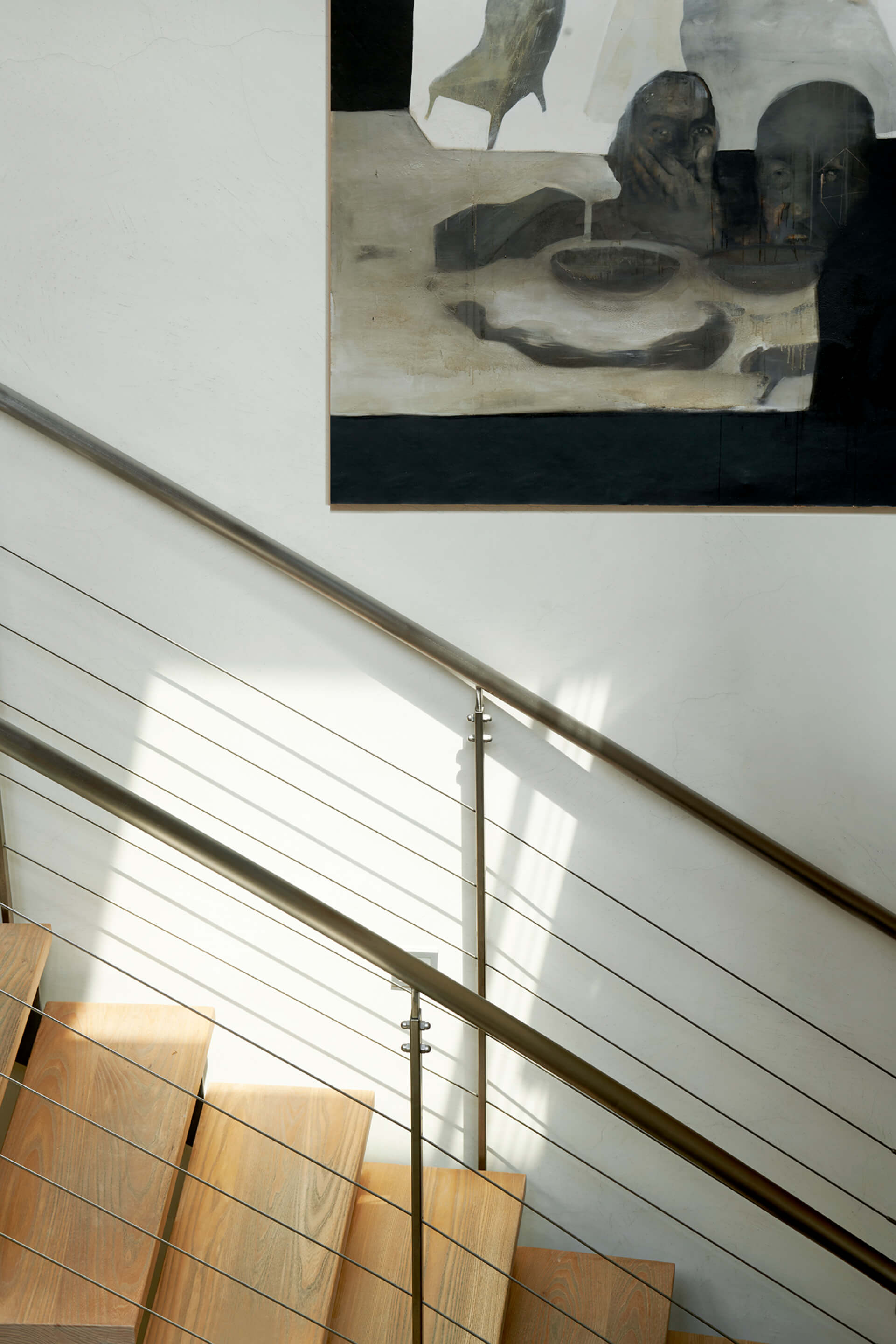 Staircase and a picture on the wall light coming from a roof window