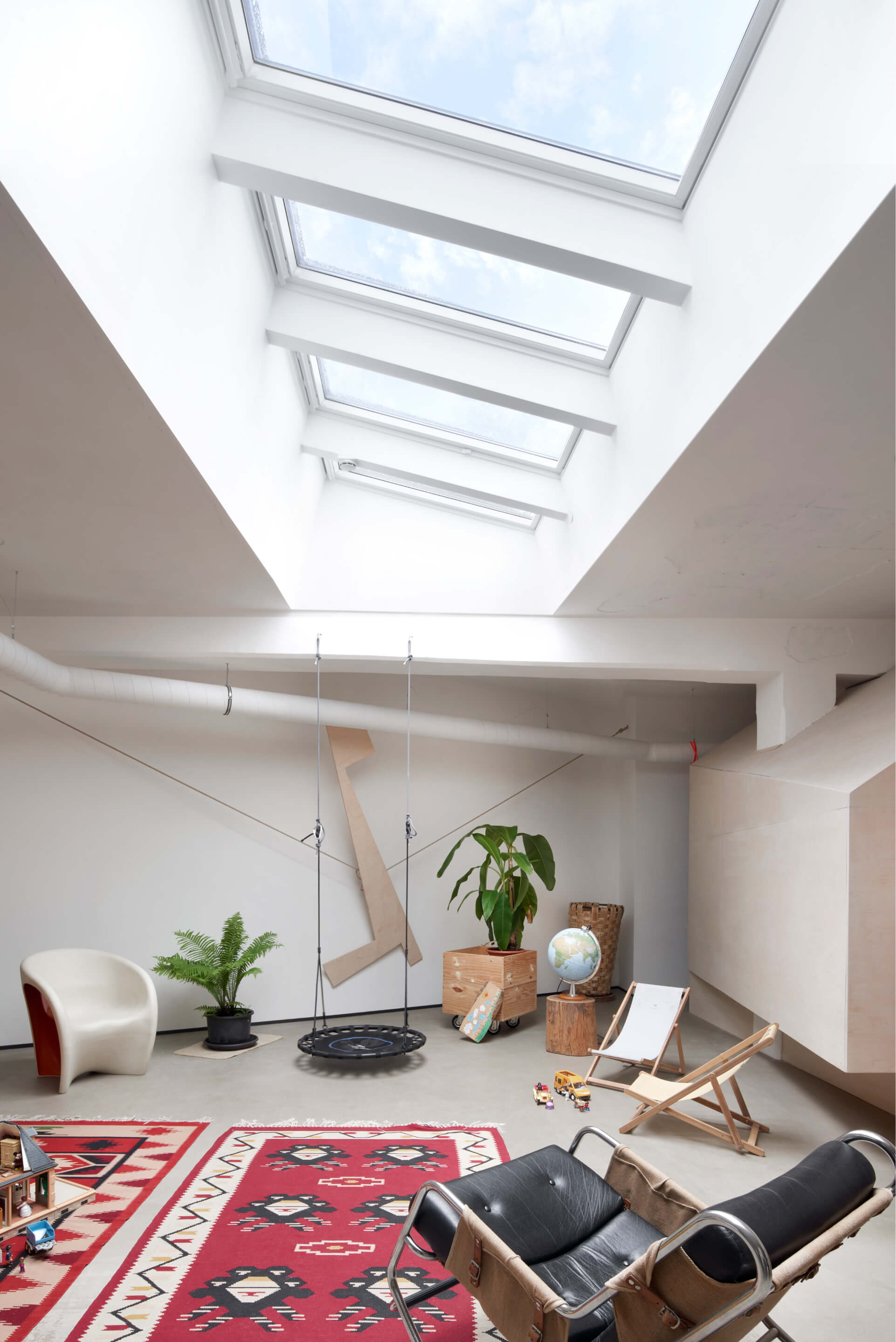 Bright living room with a lot of roof windows 