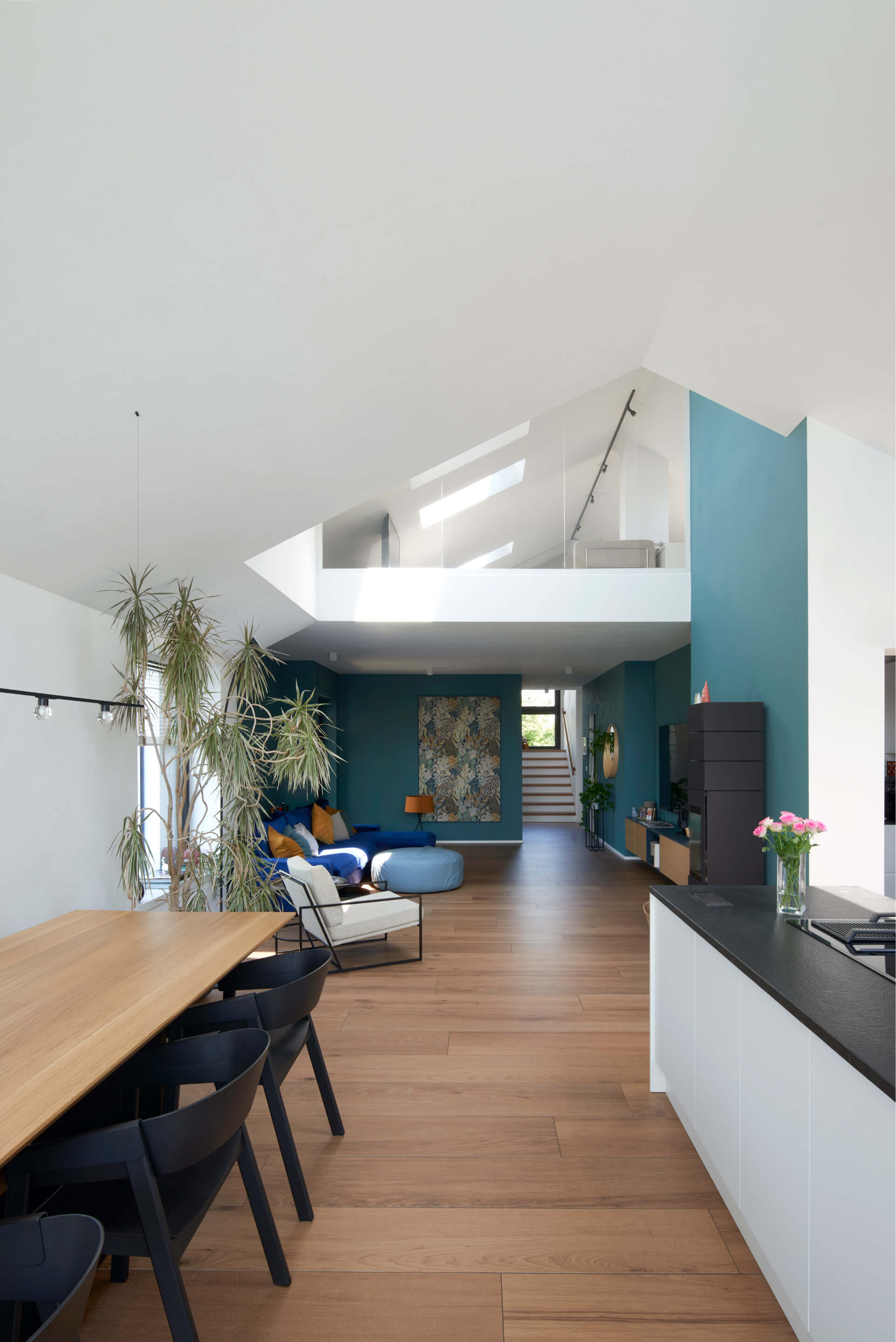 Bright kitchen and living room detail with roof windows in the attic